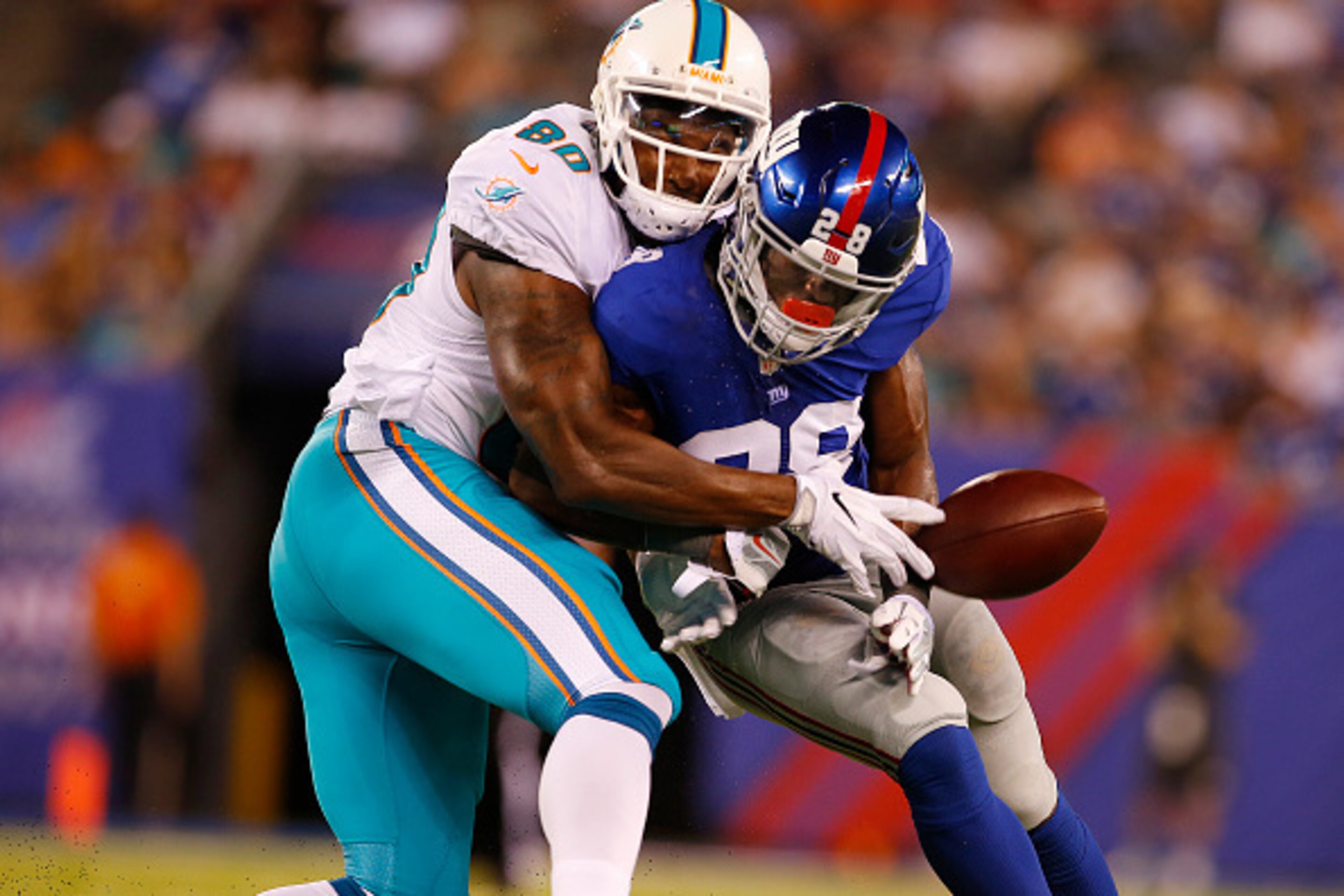 EAST RUTHERFORD, NJ - AUGUST 12: Eli Apple #28 of the New York Giants breaks up a pass intended for Dion Sims #80 of the Miami Dolphins during the first half of an NFL preseason game at MetLife Stadium on August 12, 2016 in East Rutherford, New Jersey. Th