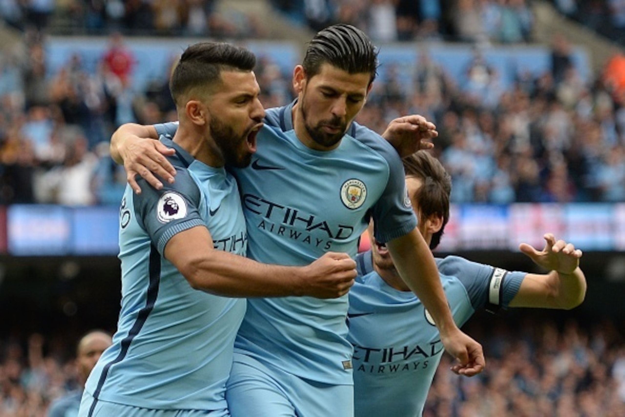 Manchester City's Argentinian striker Sergio Aguero (L) celebrates scoring the opening goal from the penalty spot with Manchester City's Spanish midfielder Nolito (C) and Manchester City's Spanish midfielder David Silva (R) during the English Premier Leag