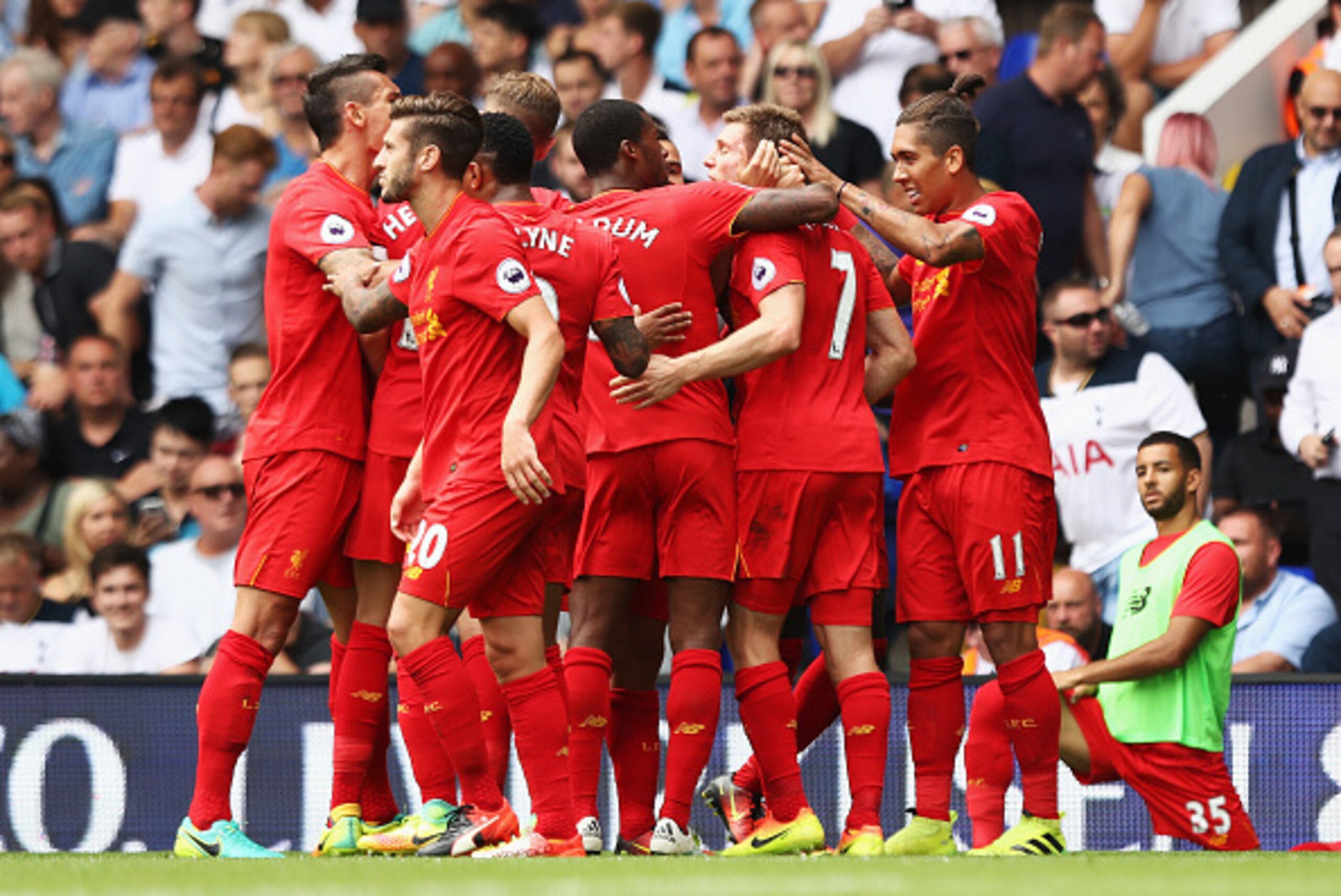 LONDON, ENGLAND - AUGUST 27: James Milner of Liverpool celebrates scoring his sides first goal with his team mates during the Premier League match between Tottenham Hotspur and Liverpool at White Hart Lane on August 27, 2016 in London, England.  (Photo by