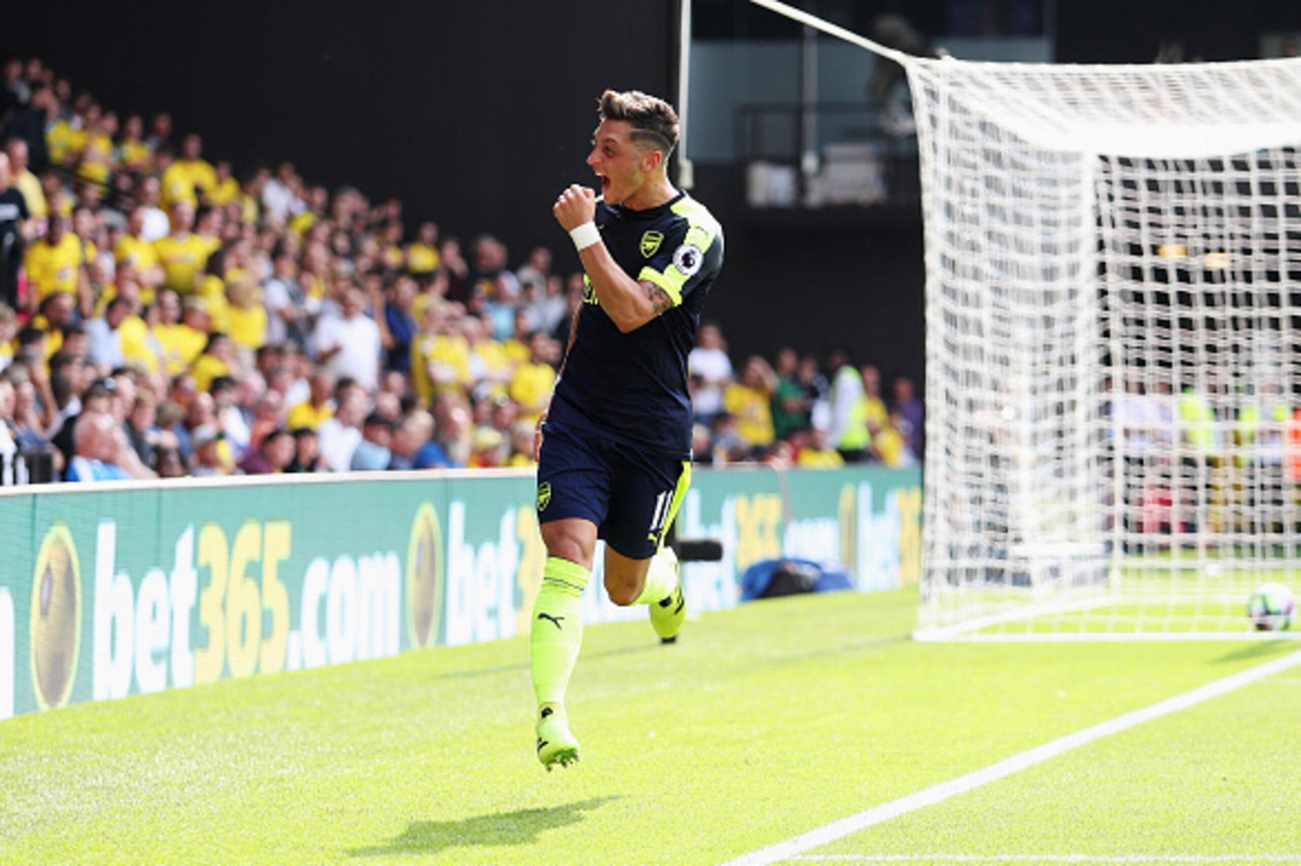WATFORD, ENGLAND - AUGUST 27: Mesut Ozil of Arsenal celebrates scoring his sides third goal during the Premier League match between Watford and Arsenal at Vicarage Road on August 27, 2016 in Watford, England.  (Photo by Christopher Lee/Getty Images)