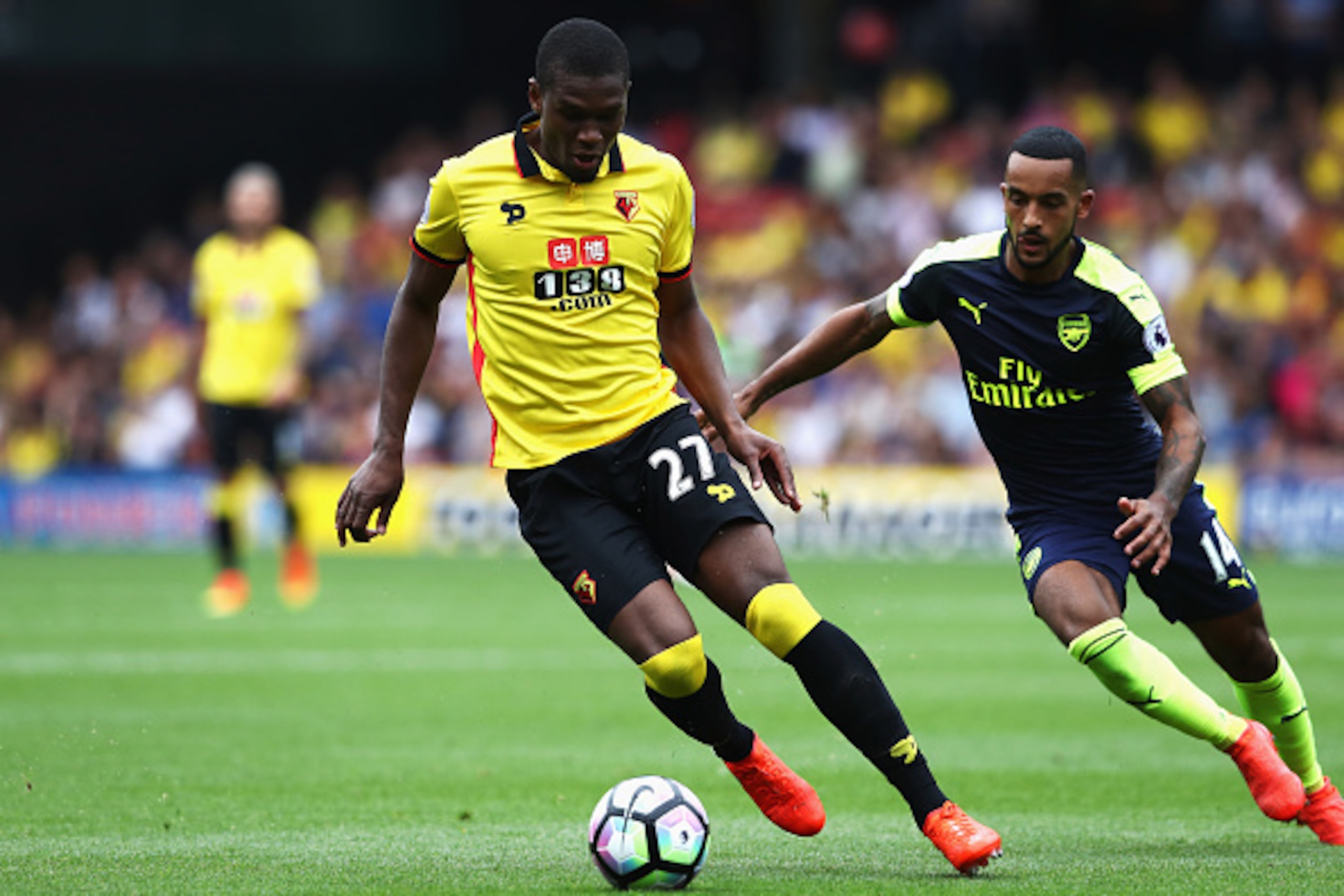 WATFORD, ENGLAND - AUGUST 27:  Christian Kabasele of Watford takes the ball away from Theo Walcott of Arsenal during the Premier League match between Watford and Arsenal at Vicarage Road on August 27, 2016 in Watford, England.  (Photo by David Rogers/Gett