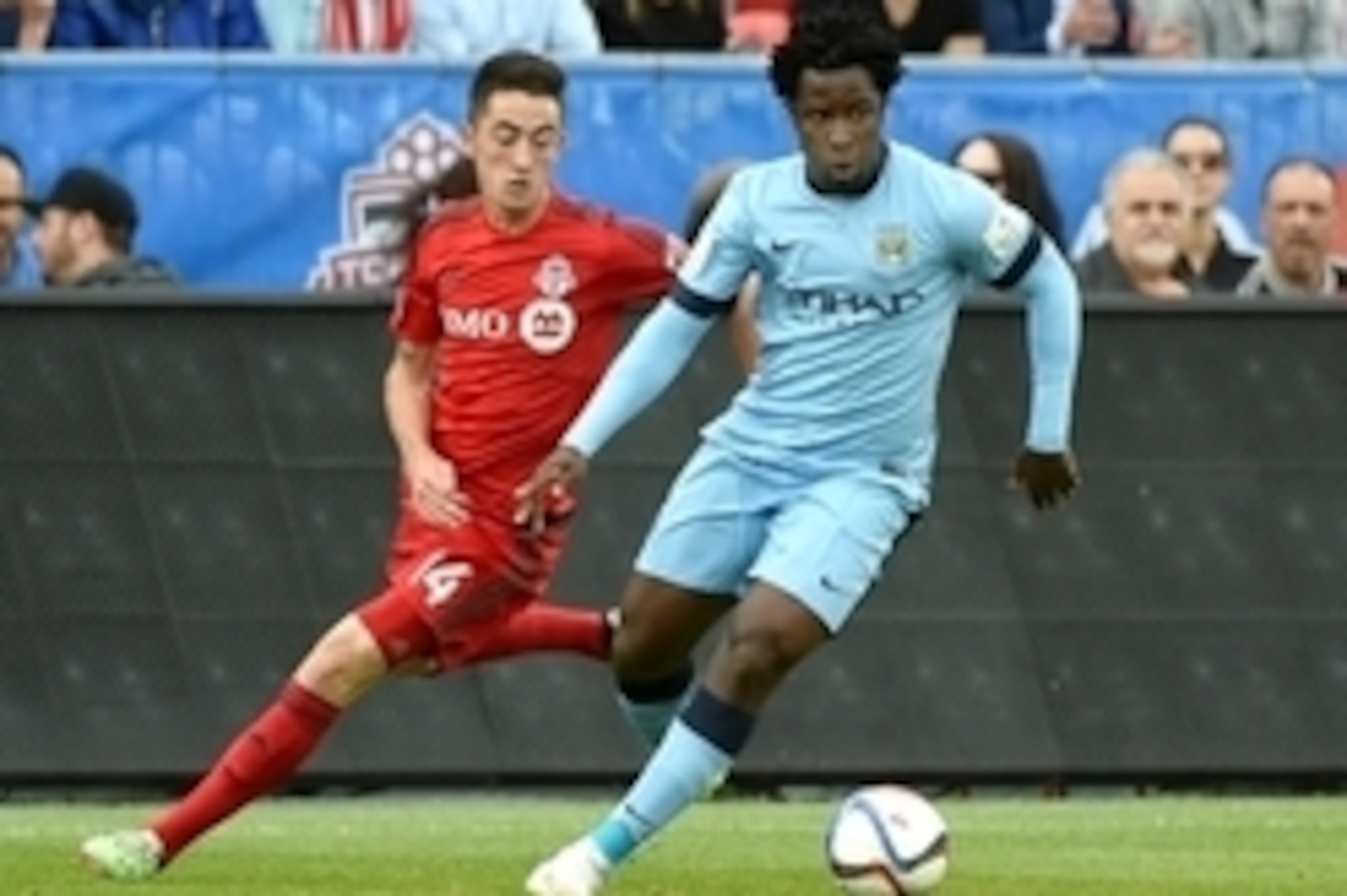 May 27, 2015; Toronto, Ontario, Canada;  Manchester City forward Wilfried Bony (14) shields the ball from Toronto FC midfielder Jay Chapman (14) during the first half of an international club friendly at BMO Field. Mandatory Credit: Dan Hamilton-USA TODAY