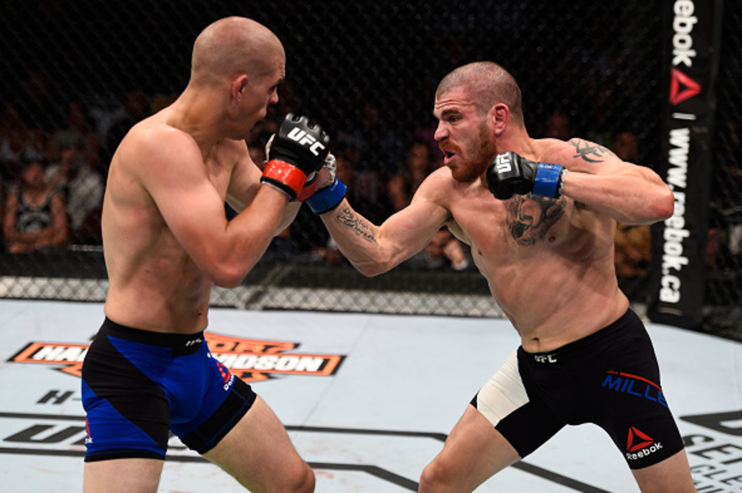 VANCOUVER, BC - AUGUST 27:  (R-L) Jim Miller of the United States punches Joe Lauzon of the United States in their lightweight bout during the UFC Fight Night event at Rogers Arena on August 27, 2016 in Vancouver, British Columbia, Canada. (Photo by Jeff 