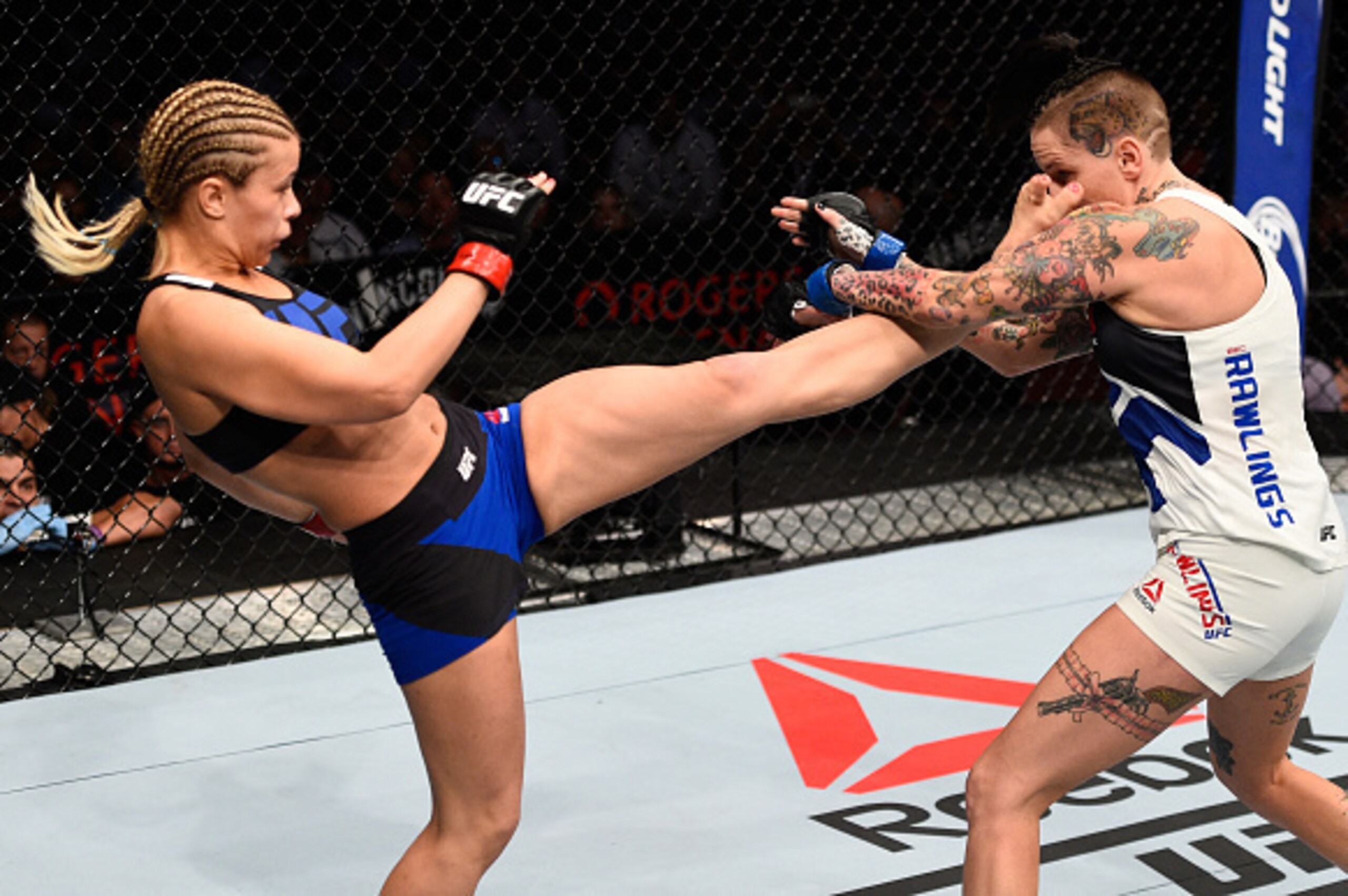 VANCOUVER, BC - AUGUST 27:  (L-R) Paige VanZant of the United States kicks Bec Rawlings of Australia in their women's strawweight bout during the UFC Fight Night event at Rogers Arena on August 27, 2016 in Vancouver, British Columbia, Canada. (Photo by Je