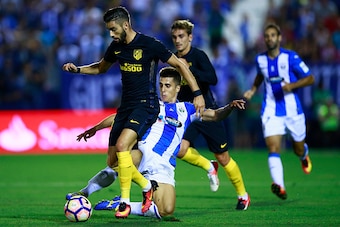 LEGANES, SPAIN - AUGUST 27: Unai Bustinza (L) of Deportivo Leganes blocks Yannick Carrasco's (L) attack during the La Liga match between Club Deportivo Leganes and Club Atletico de Madrid at Estadio Municipal de Butarque on August 27, 2016 in Leganes, Spa