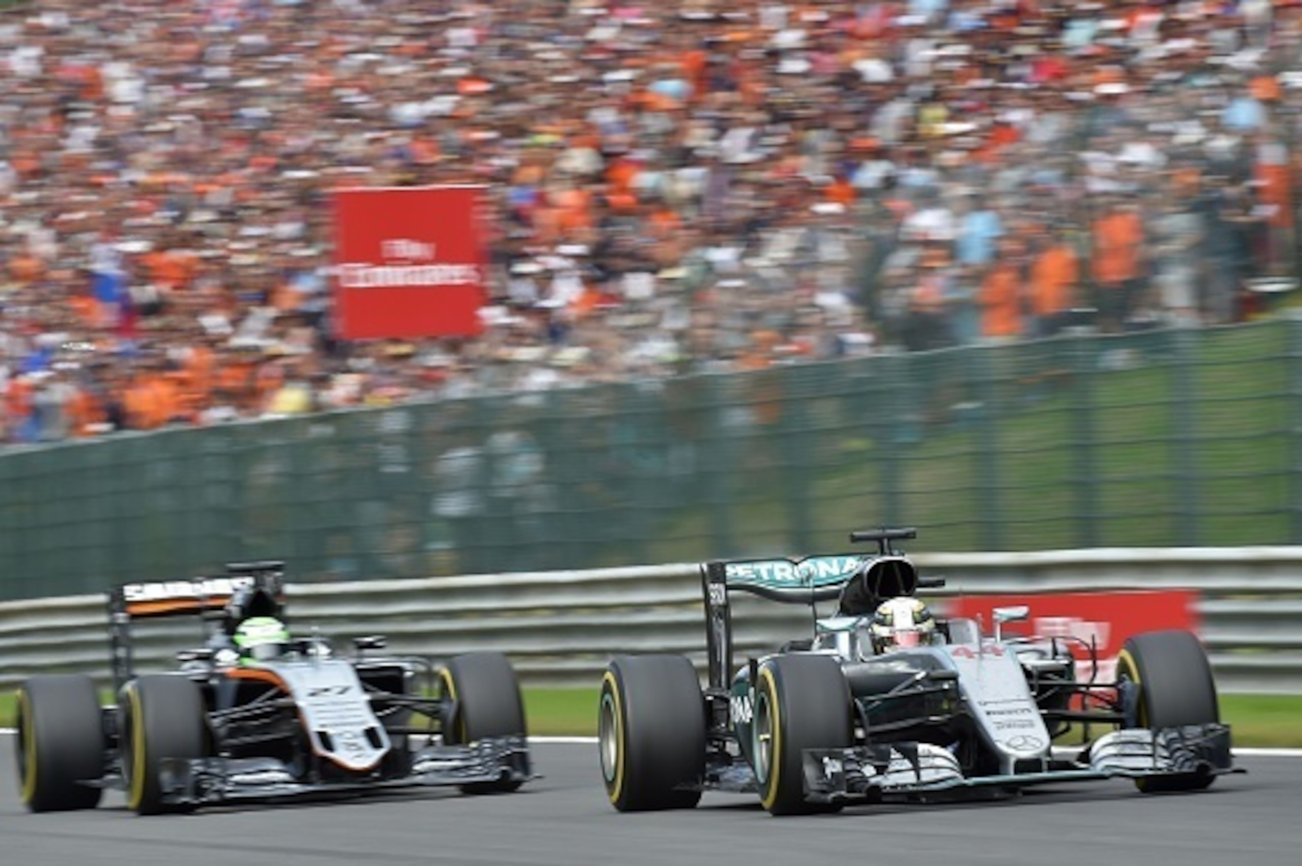 Mercedes AMG Petronas F1 Team's British driver Lewis Hamilton (R) passes ahead of Sahara Force India F1 Team's German driver Nico Hulkenberg during the Belgian Formula One Grand Prix at the Spa-Francorchamps circuit in Spa on August 28, 2016. / AFP / LOI Mercedes AMG Petronas F1 Team's British driver Lewis Hamilton (R) passes ahead of Sahara Force India F1 Team's German driver Nico Hulkenberg during the Belgian Formula One Grand Prix at the Spa-Francorchamps circuit in Spa on August 28, 2016. / AFP / LOI