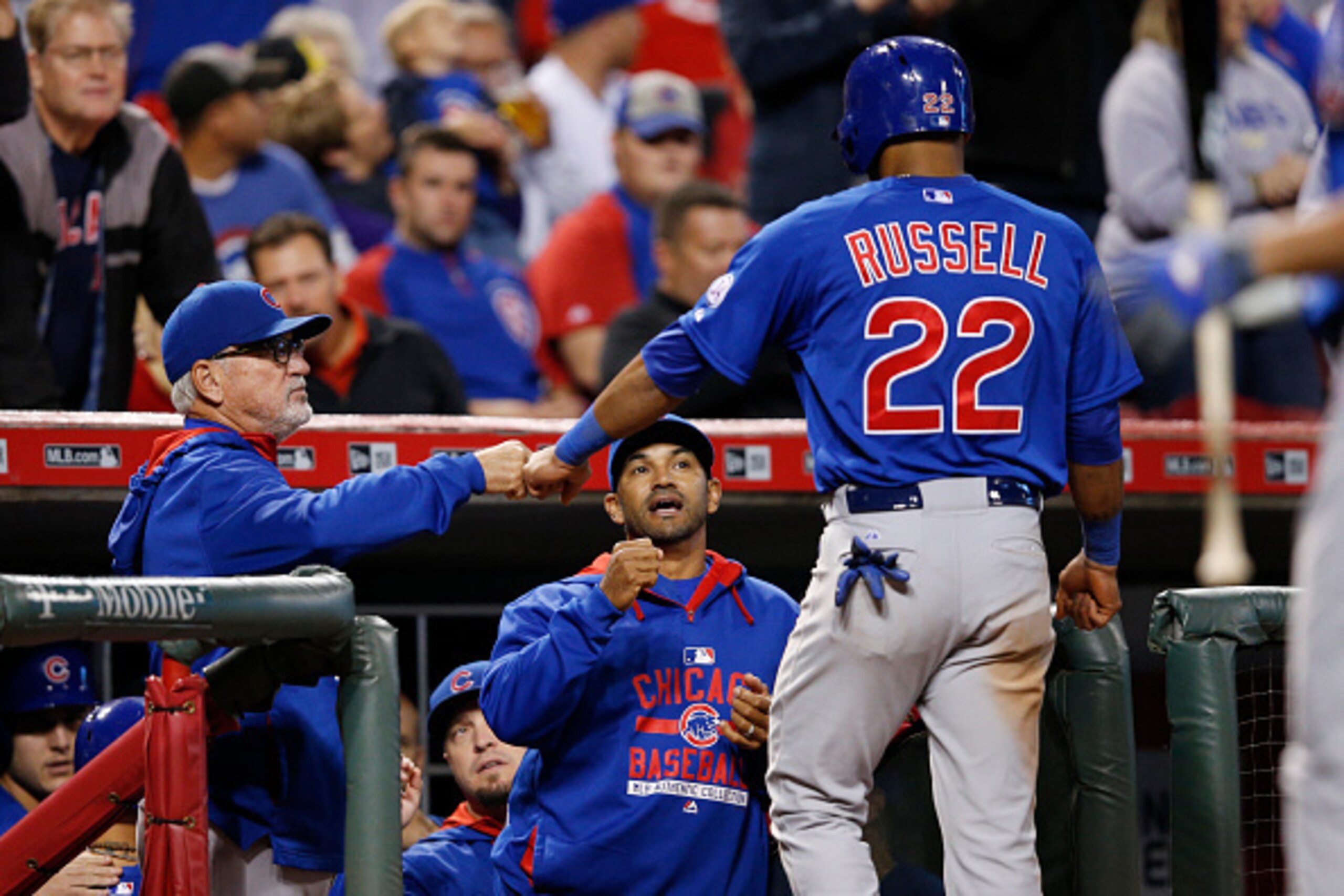 CINCINNATI, OH - SEPTEMBER 30: Manager Joe Maddon of the Chicago Cubs congratulates Addison Russell #22 after he scored on a single by Austin Jackson in the eighth inning against the Cincinnati Reds at Great American Ball Park on September 30, 2015 in Cin
