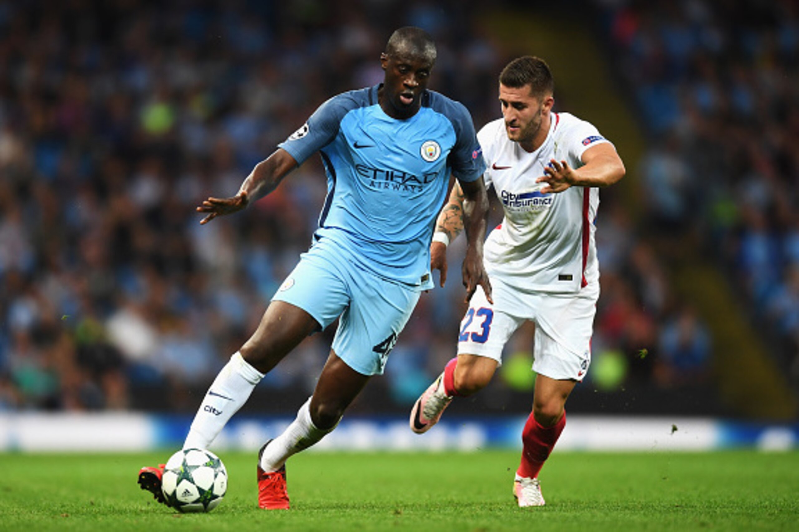 MANCHESTER, ENGLAND - AUGUST 24: Yaya Toure of Manchester City is closed down by Ovidiu Popescu of Steaua Bucharest during the UEFA Champions League Play-off Second Leg match between Manchester City and Steaua Bucharest at Etihad Stadium on August 24, 20 MANCHESTER, ENGLAND - AUGUST 24: Yaya Toure of Manchester City is closed down by Ovidiu Popescu of Steaua Bucharest during the UEFA Champions League Play-off Second Leg match between Manchester City and Steaua Bucharest at Etihad Stadium on August 24, 20