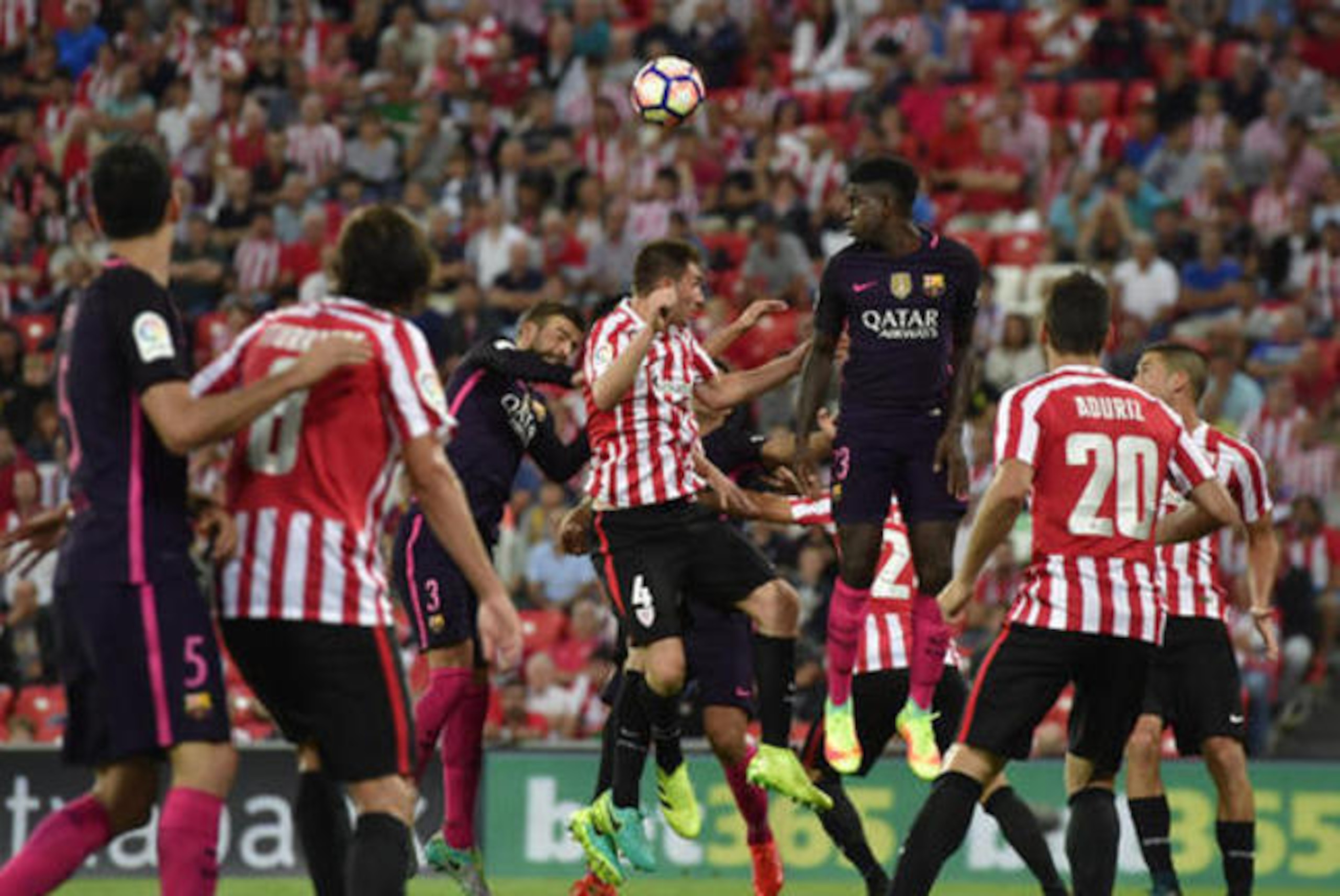 Samuel Umtiti rises to nod the ball away.