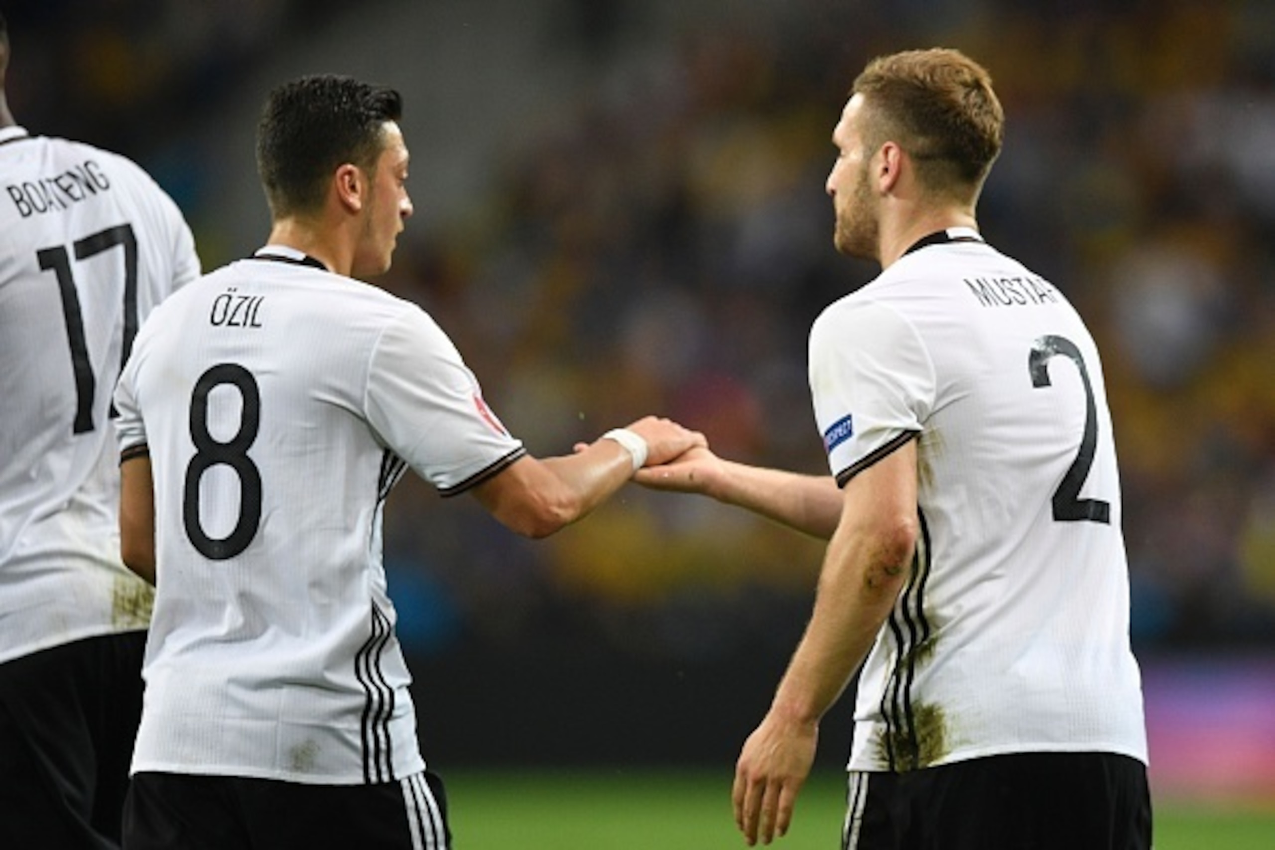 Germany's defender Shkodran Mustafi (R) celebrates with Germany's midfielder Mesut Oezil after scoring a goal during the Euro 2016 group C football match between Germany and Ukraine at the Stade Pierre Mauroy in Villeneuve-d'Ascq near Lille on June 12, 20