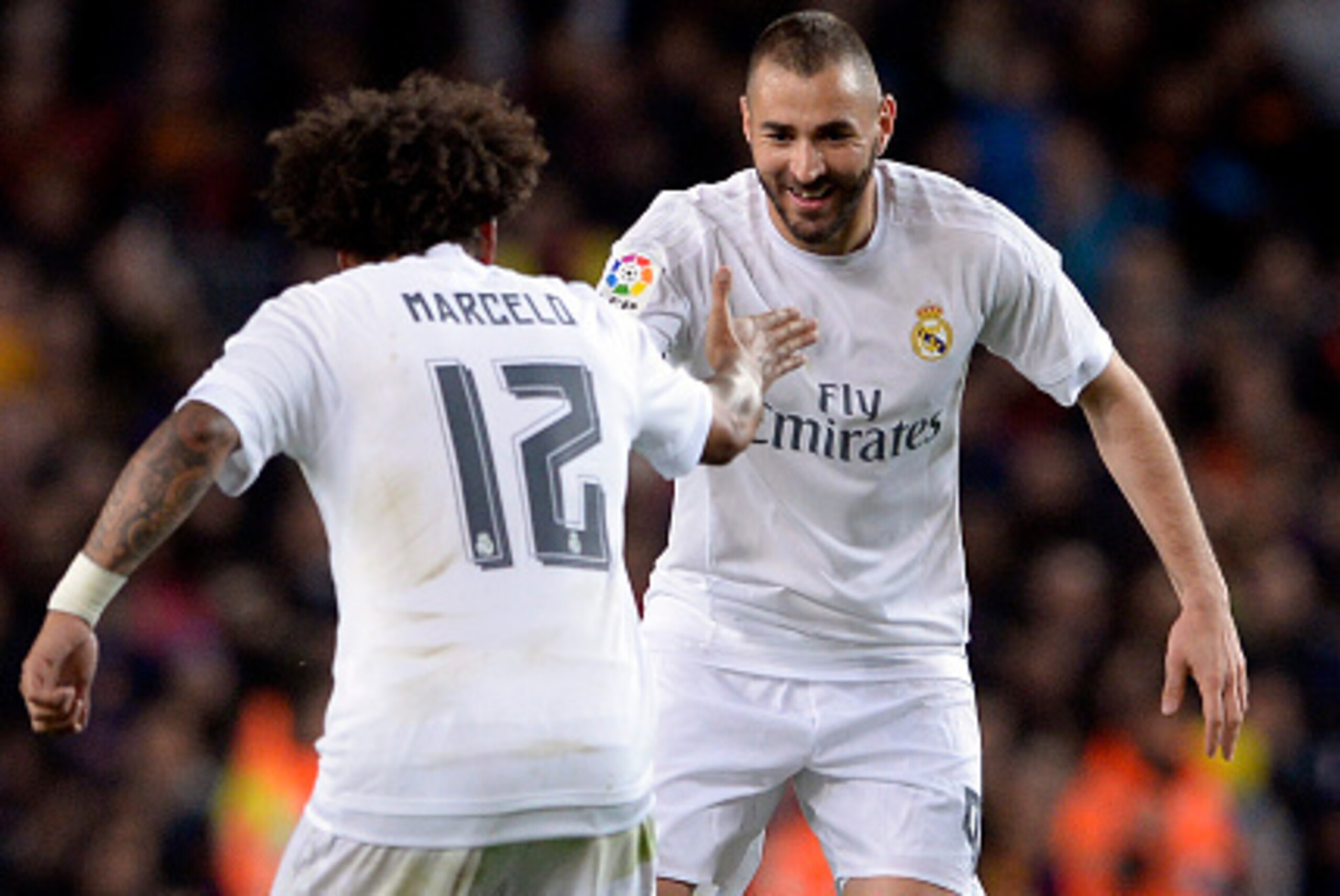 Real Madrid's French forward Karim Benzema (R) celebrates a goal with Real Madrid's Brazilian defender Marcelo during the Spanish league 'Clasico' football match FC Barcelona vs Real Madrid CF at the Camp Nou stadium in Barcelona on April 2, 2016. / AFP /