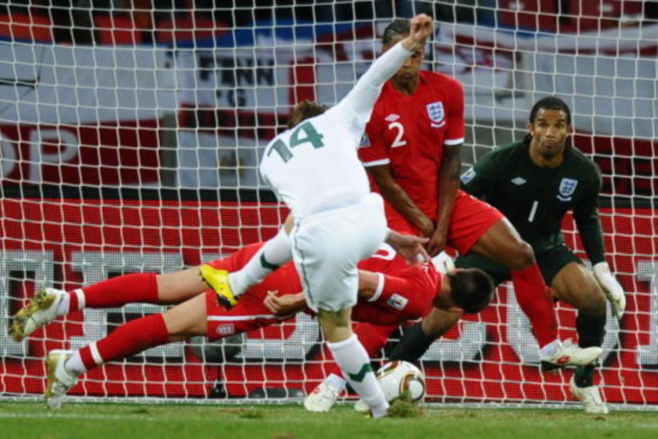 England's defender John Terry (C, back) deflects a shot by Slovenia's striker Zlatko Dedic (C) in front of England's goalkeeper David James (R) during the Group C first round 2010 World Cup football match Slovenia vs. England on June 23, 2010 at Nelson Ma