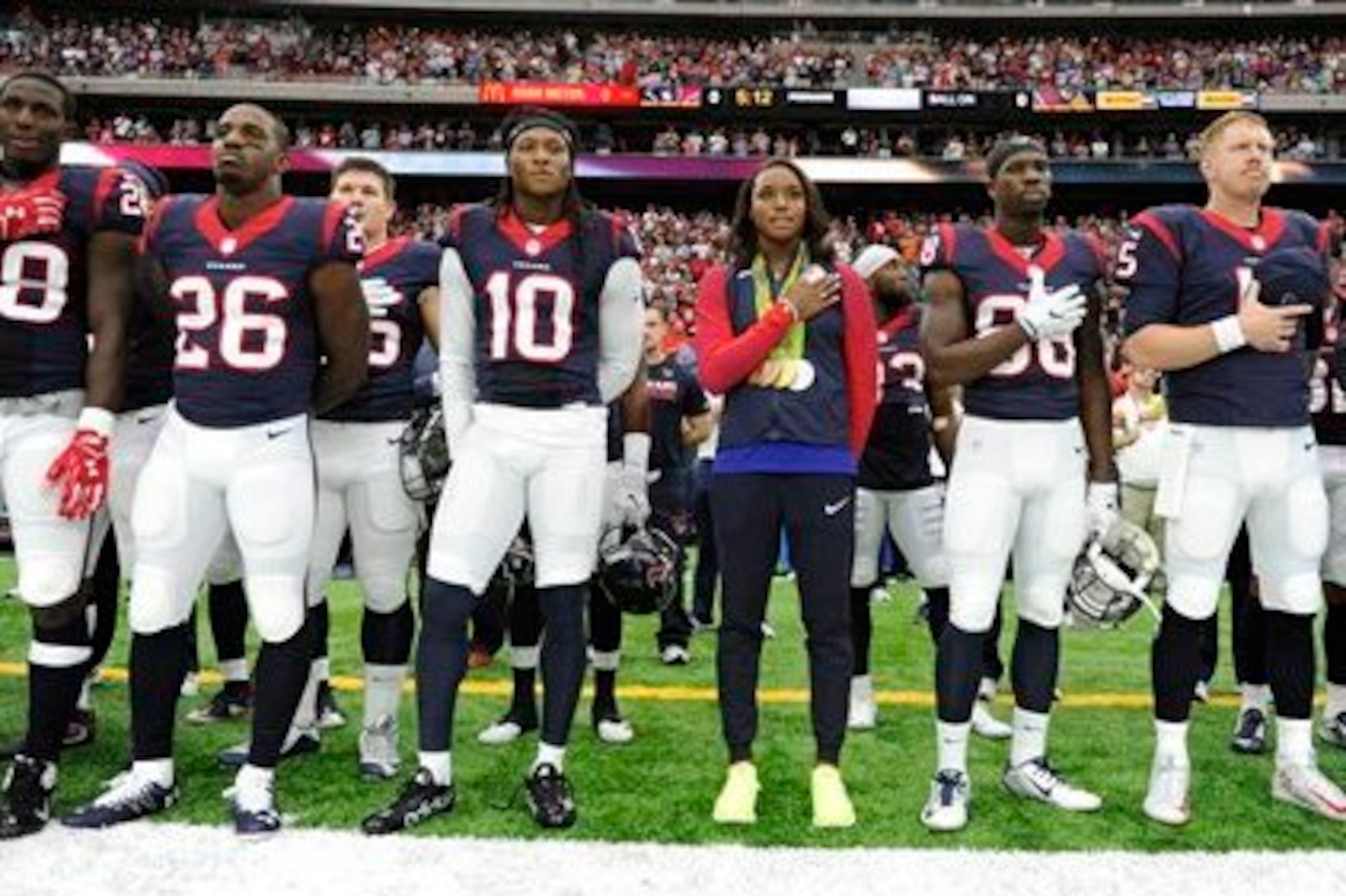 The Texans during the National Anthem on Sunday. We are suddenly paying much more attention to who is standing.
