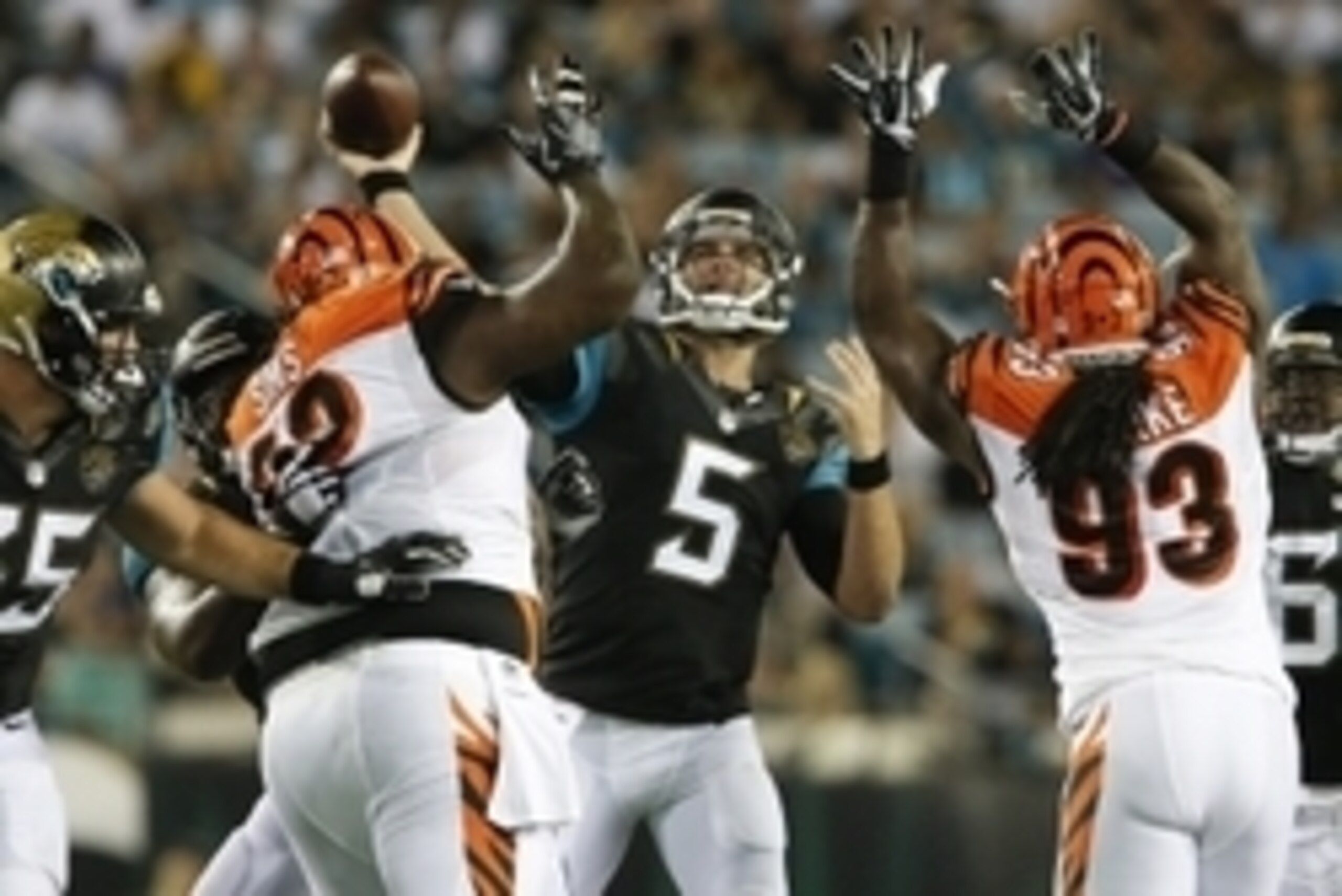 Aug 28, 2016; Jacksonville, FL, USA;  Jacksonville Jaguars quarterback Blake Bortles (5) makes a pass against Cincinnati Bengals defensive end Will Clarke (93) and linebacker Trevor Roach (52) during the second quarter of a football game at EverBank Field