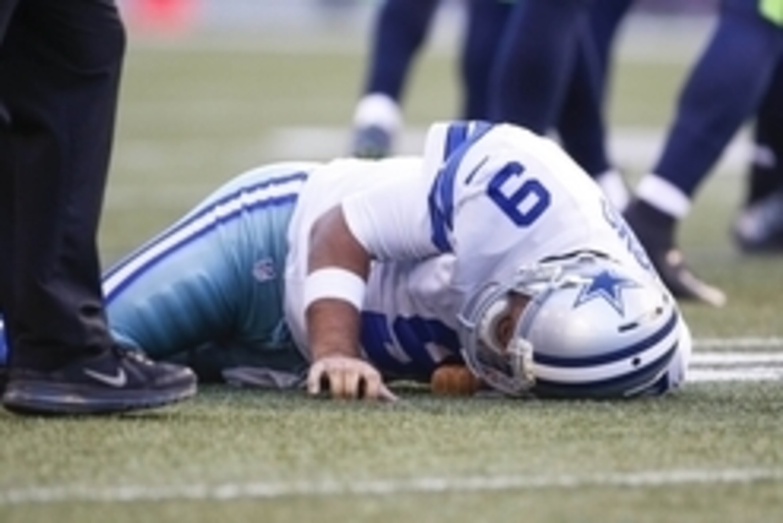 Aug 25, 2016; Seattle, WA, USA; Dallas Cowboys quarterback Tony Romo (9) lies on the turf after a tackle against the Seattle Seahawks during the first quarter at CenturyLink Field. Mandatory Credit: Joe Nicholson-USA TODAY Sports