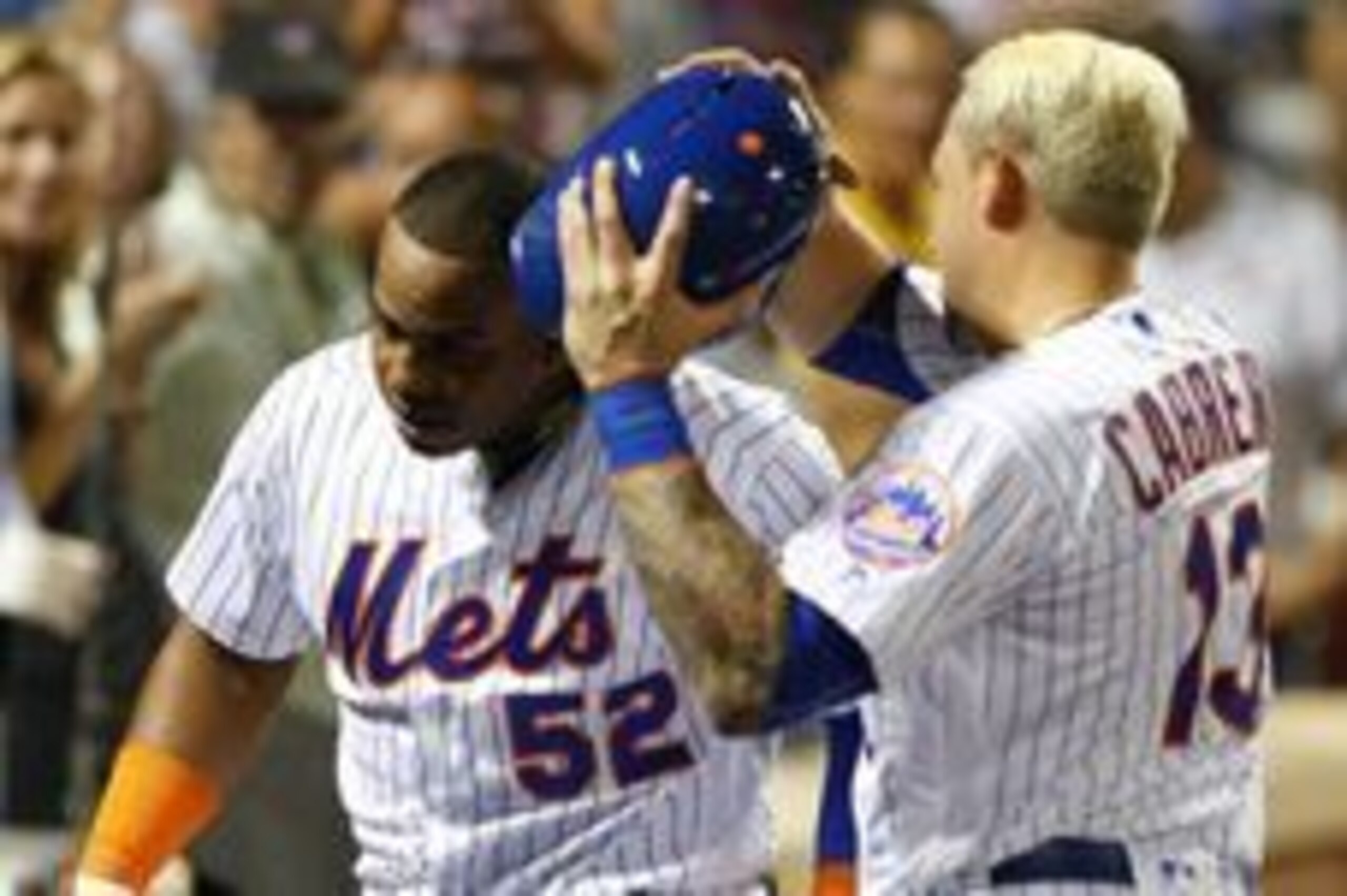 Aug 27, 2016; New York City, NY, USA;  New York Mets shortstop Asdrubal Cabrera (13) removes New York Mets center fielder Yoenis Cespedes (52) helmet after he hit a home run in the fourth inning against the Philadelphia Phillies at Citi Field. Mandatory C