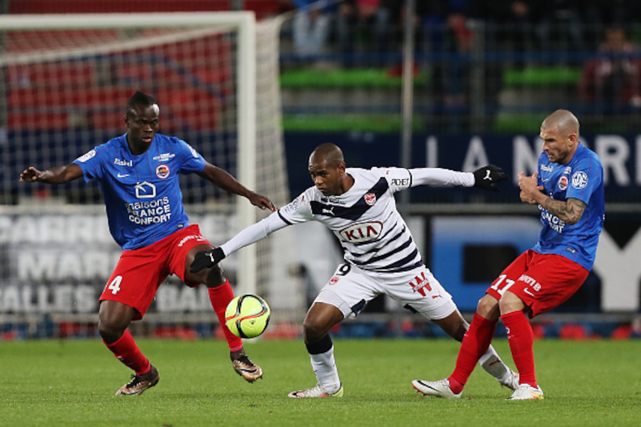 Bordeaux's Uruguayan forward Diego Rolan (C) vies for the ball with Caen's Ivorian midfielder Tiemoko Ismael Diomande (L) and Caen's French midfielder Vincent Bessat (R) during the French Ligue 1 football match between Caen (SM Caen) and Bordeaux (FCG Bor