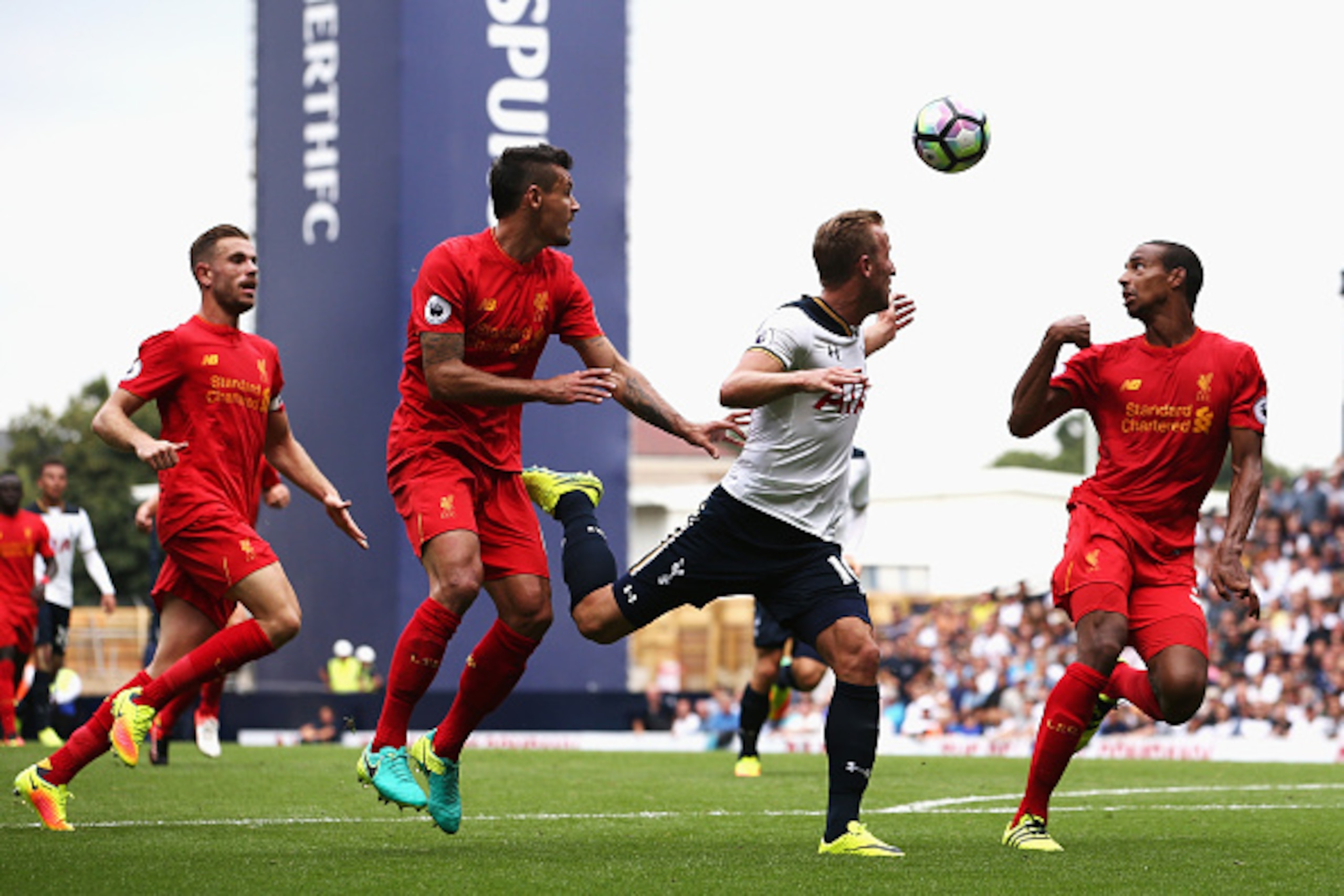 LONDON, ENGLAND - AUGUST 27: Harry Kane of Tottenham Hotspur (C), Dejan Lovren of Liverpool (L) and Joel Matip of Liverpool all watch the ball during the Premier League match between Tottenham Hotspur and Liverpool at White Hart Lane on August 27, 2016 in