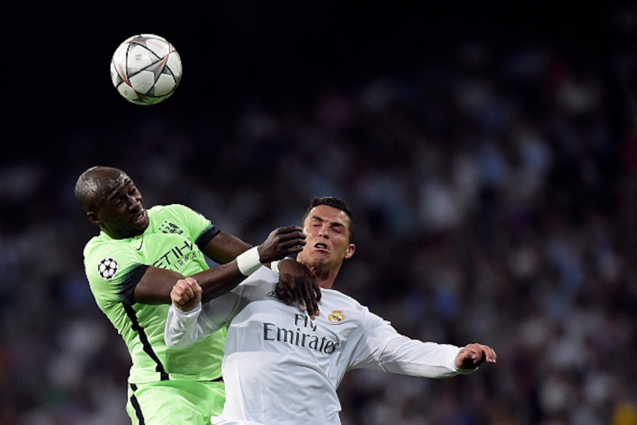 TOPSHOT - Manchester City's French defender Eliaquim Mangala (L) vies with Real Madrid's Portuguese forward Cristiano Ronaldo during the UEFA Champions League semi-final second leg football match Real Madrid CF vs Manchester City FC at the Santiago Bernab