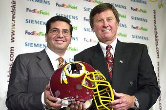 ASHBURN, :  Washington Redskins' owner Daniel Snyder (L) and new Redskins' Head Coach Steve Spurrier pose for photographers 15 January 2002 during a press conference at Redskins Park in Ashburn, Virginia. Spurrier is now the highest paid coach in the NFL.