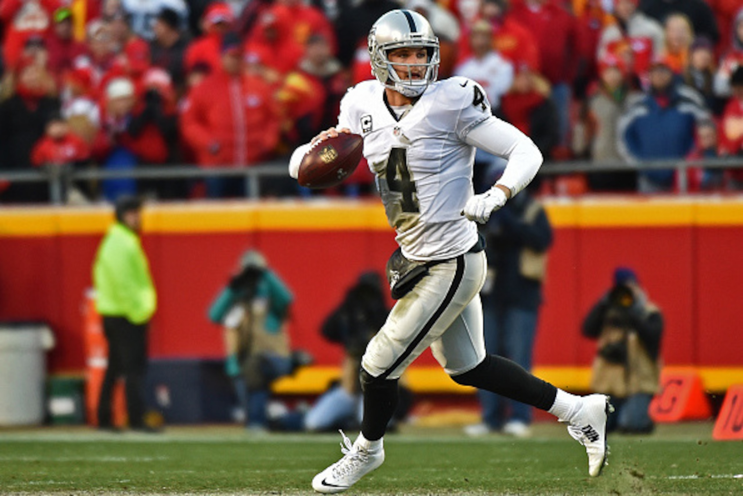 KANSAS CITY, MO - JANUARY 03:  Quarterback Derek Carr #4 of the Oakland Raiders drops back to pass against the Kansas City Chiefs during the first half on January 3, 2016 at Arrowhead Stadium in Kansas City, Missouri.  (Photo by Peter G. Aiken/Getty Image
