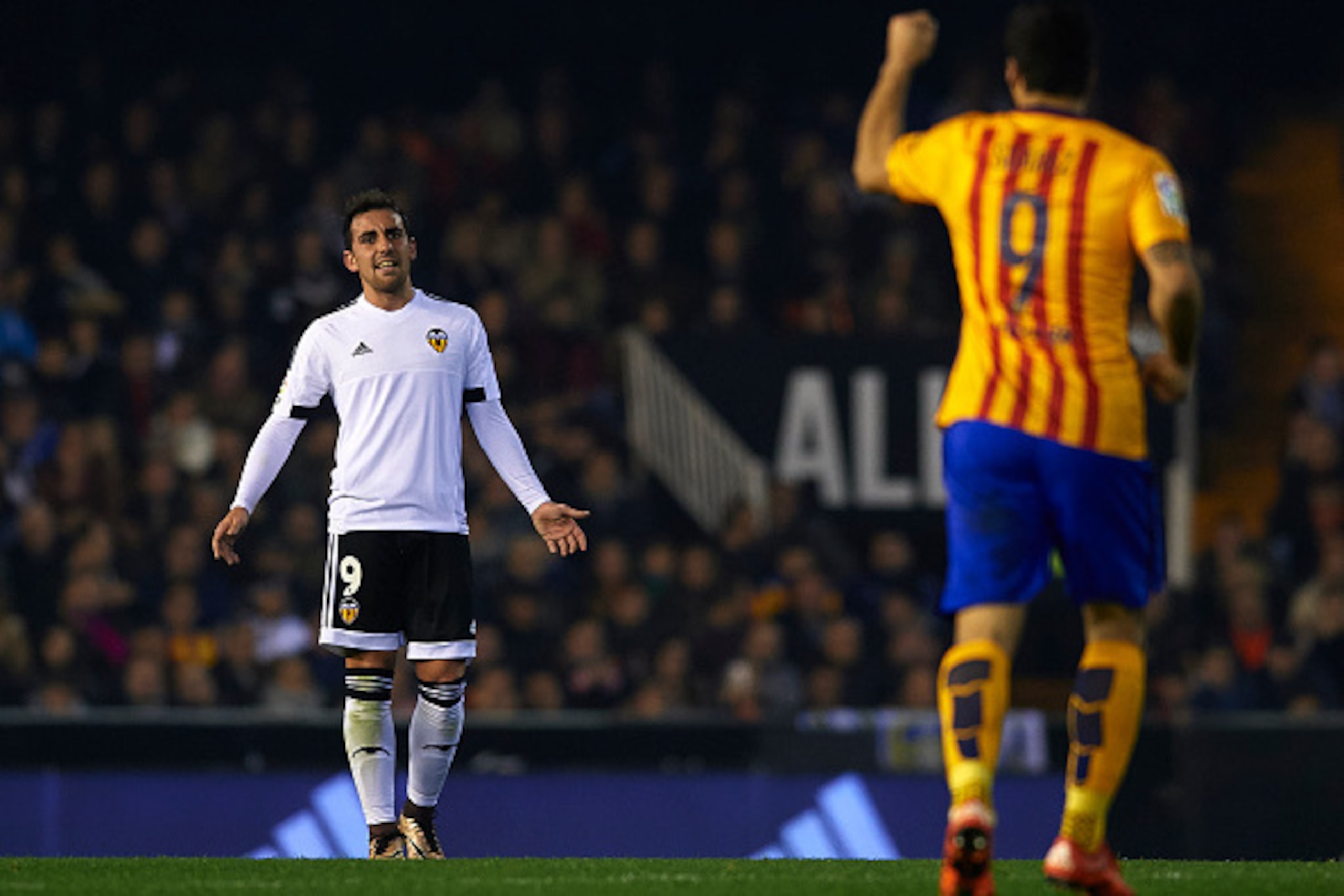 VALENCIA, SPAIN - DECEMBER 05:  Paco Alcacer (9) of Valencia reacts to Luis Suarez of Barcelona during the La Liga match between Valencia CF and FC Barcelona at Estadi de Mestalla on December 05, 2015 in Valencia, Spain.  (Photo by Manuel Queimadelos Alon