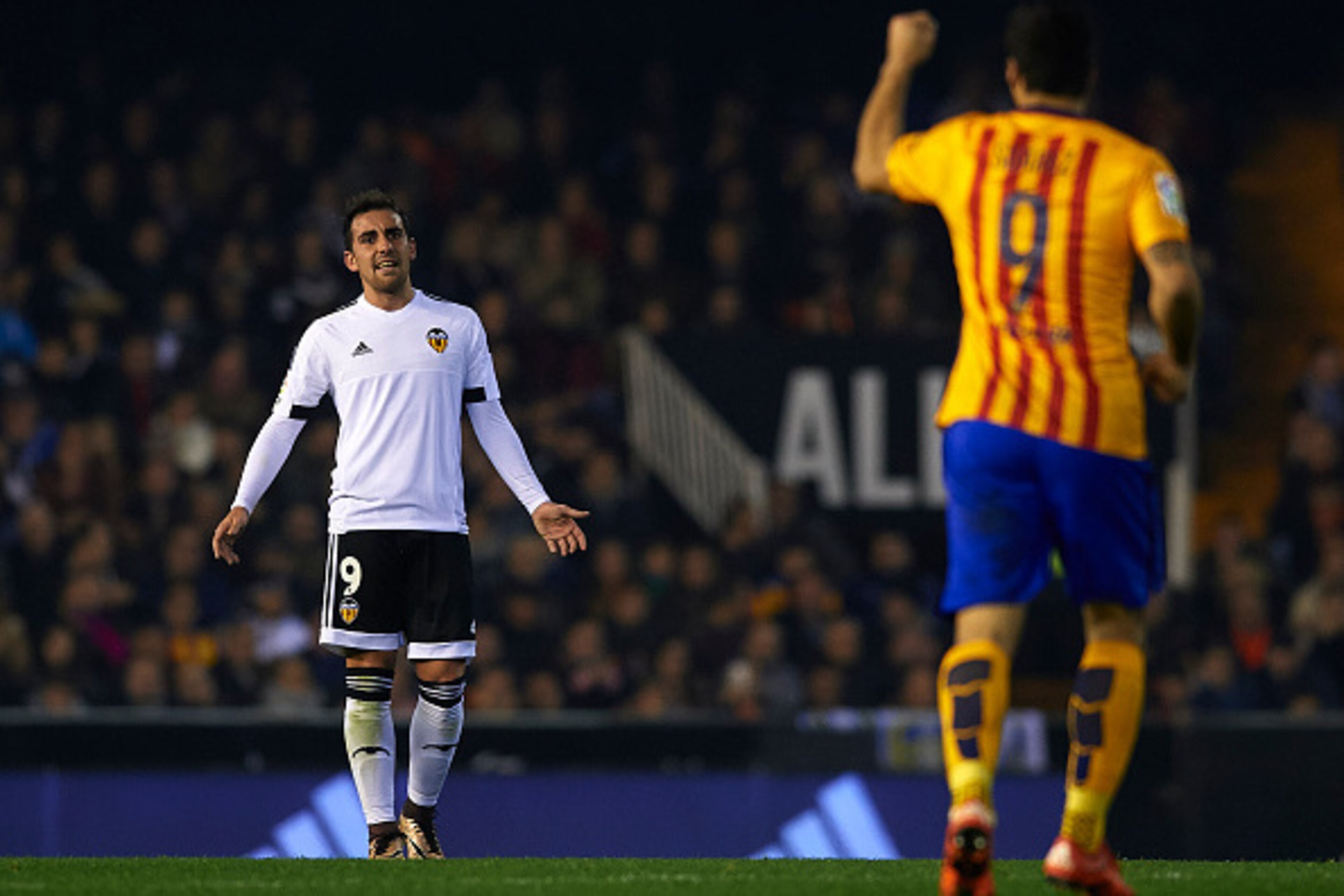 VALENCIA, SPAIN - DECEMBER 05:  Paco Alcacer (9) of Valencia reacts to Luis Suarez of Barcelona during the La Liga match between Valencia CF and FC Barcelona at Estadi de Mestalla on December 05, 2015 in Valencia, Spain.  (Photo by Manuel Queimadelos Alon