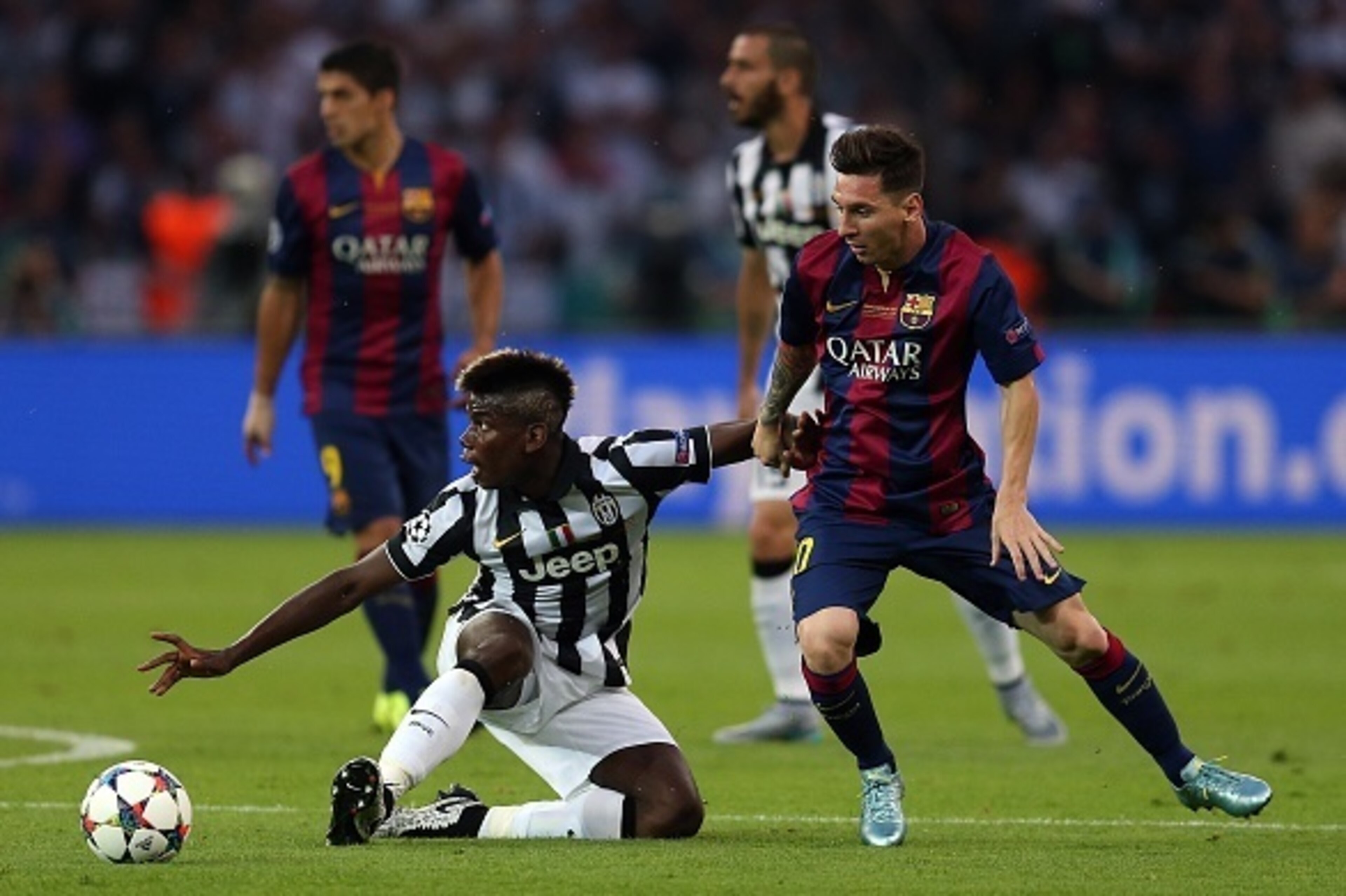 BERLIN, GERMANY - JUNE 6: Paul Pogba of Juventus in action with Lionel Messi of FC Barcelona during the UEFA Champions League Final match between Juventus and FC Barcelona at the Olympiastadion on June 6, 2015 in Berlin, Germany. (Photo by Chris Brunskill
