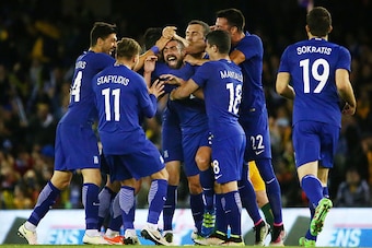 MELBOURNE, AUSTRALIA - JUNE 07:  Giannis Maniatis of Greece is congratulated by his teammates after kicking a goal from past half way during the International Friendly match between the Australian Socceroos and Greece at Etihad Stadium on June 7, 2016 in 