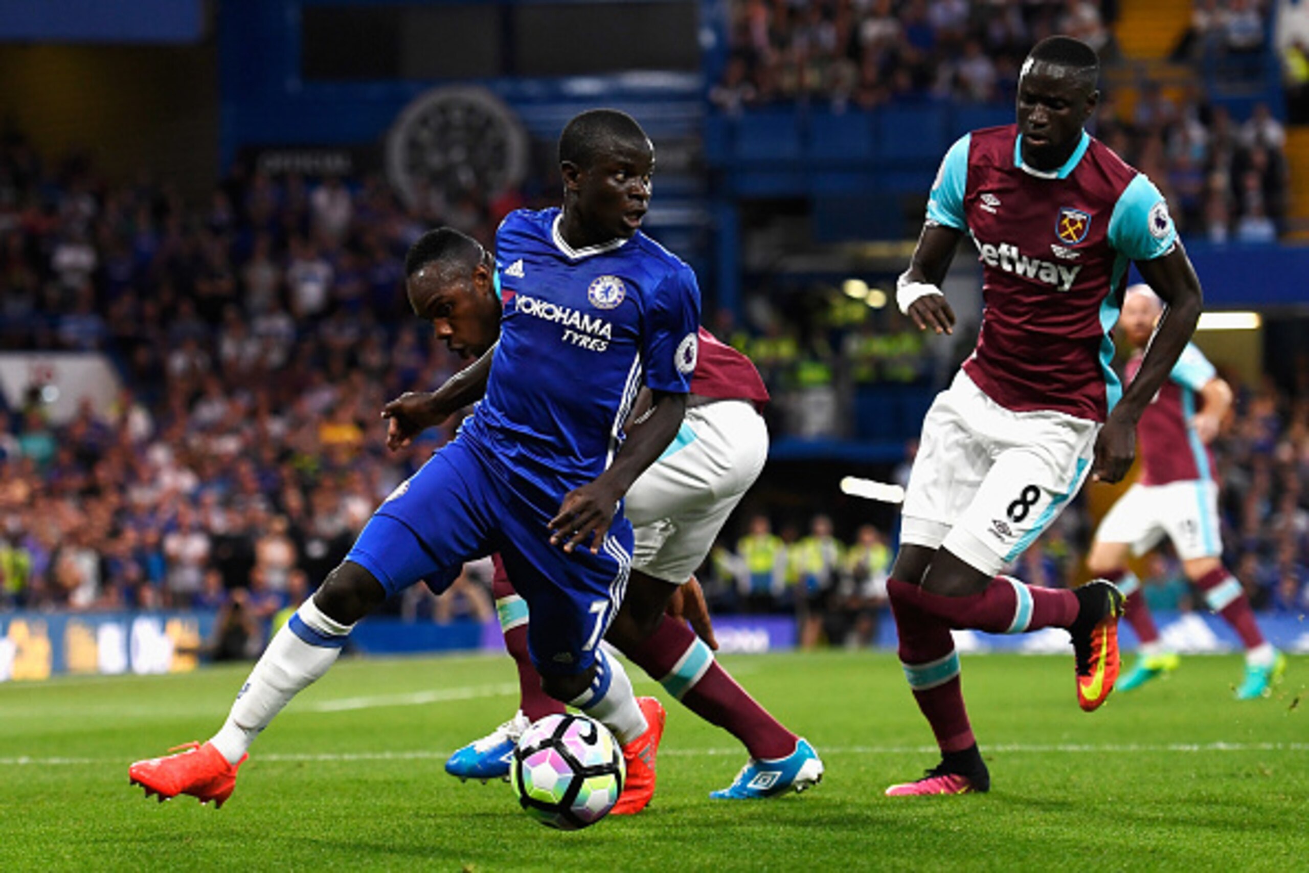 LONDON, ENGLAND - AUGUST 15:  N'Golo Kante of Chelsea is closed down by Michail Antonio and Cheikhou Kouyate of West Ham United during the Premier League match between Chelsea and West Ham United at Stamford Bridge on August 15, 2016 in London, England.  
