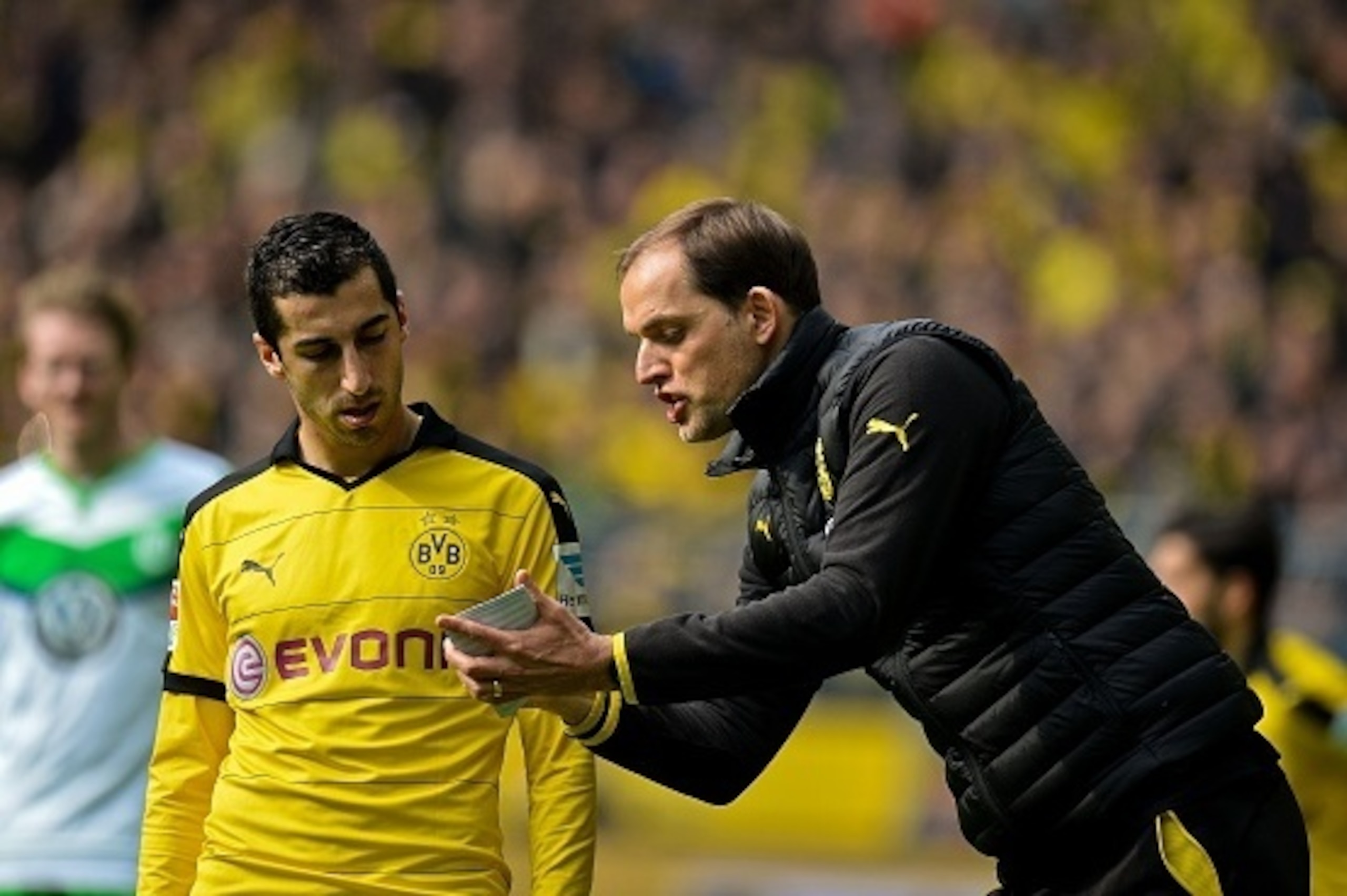 Dortmund's coach Thomas Tuchel (R) talks to Dortmund's Armenian midfielder Henrikh Mkhitaryan during the German first division Bundesliga football match Borussia Dortmund vs VfL Wolfsburg, in Dortmund, western Germany, on April 30, 2016. / AFP / Sascha SC