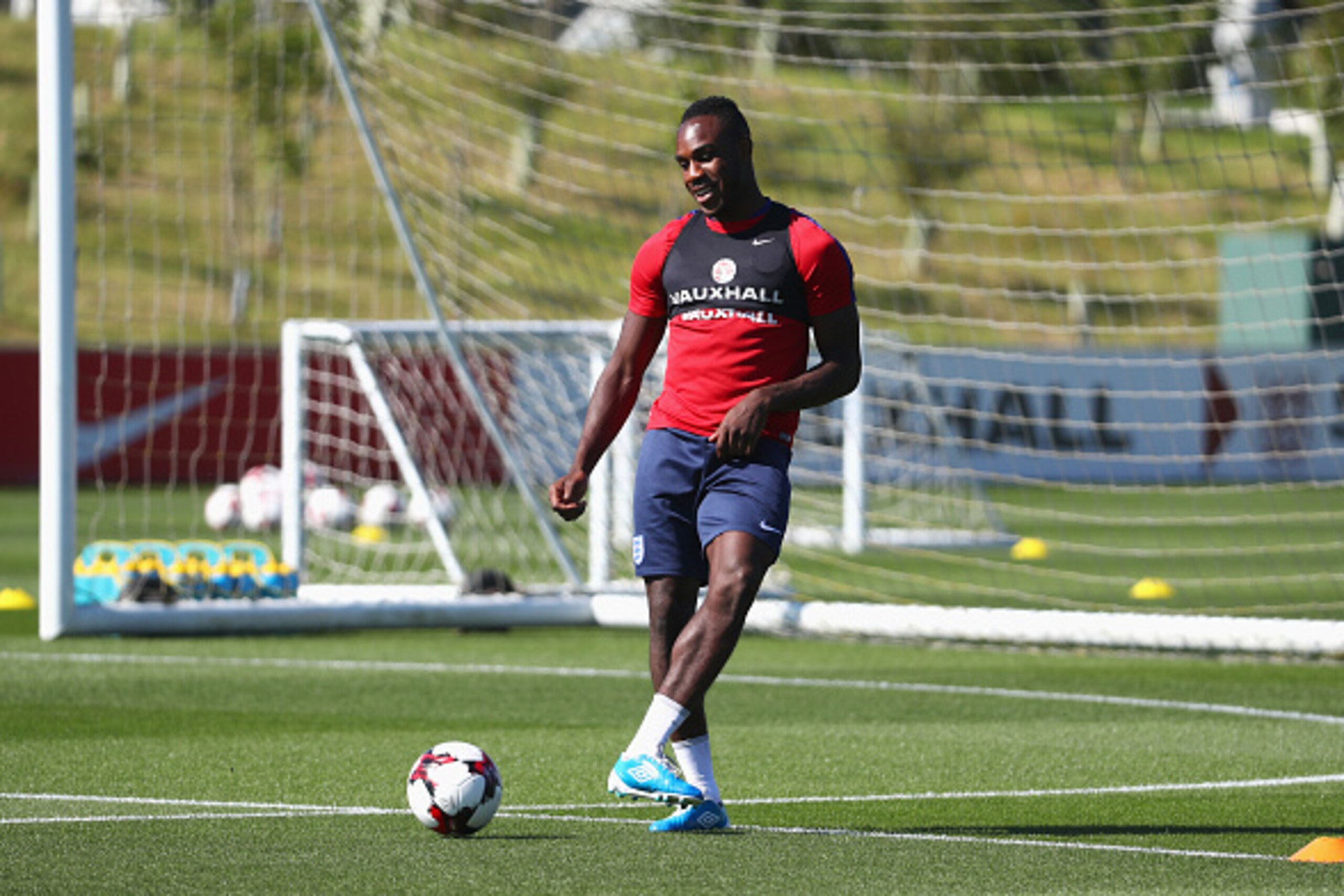 BURTON-UPON-TRENT, ENGLAND - AUGUST 30:  Michail Antonio of England passes during an England training session at St George's Park on August 30, 2016 in Burton-upon-Trent, England.  (Photo by Matthew Lewis/Getty Images)