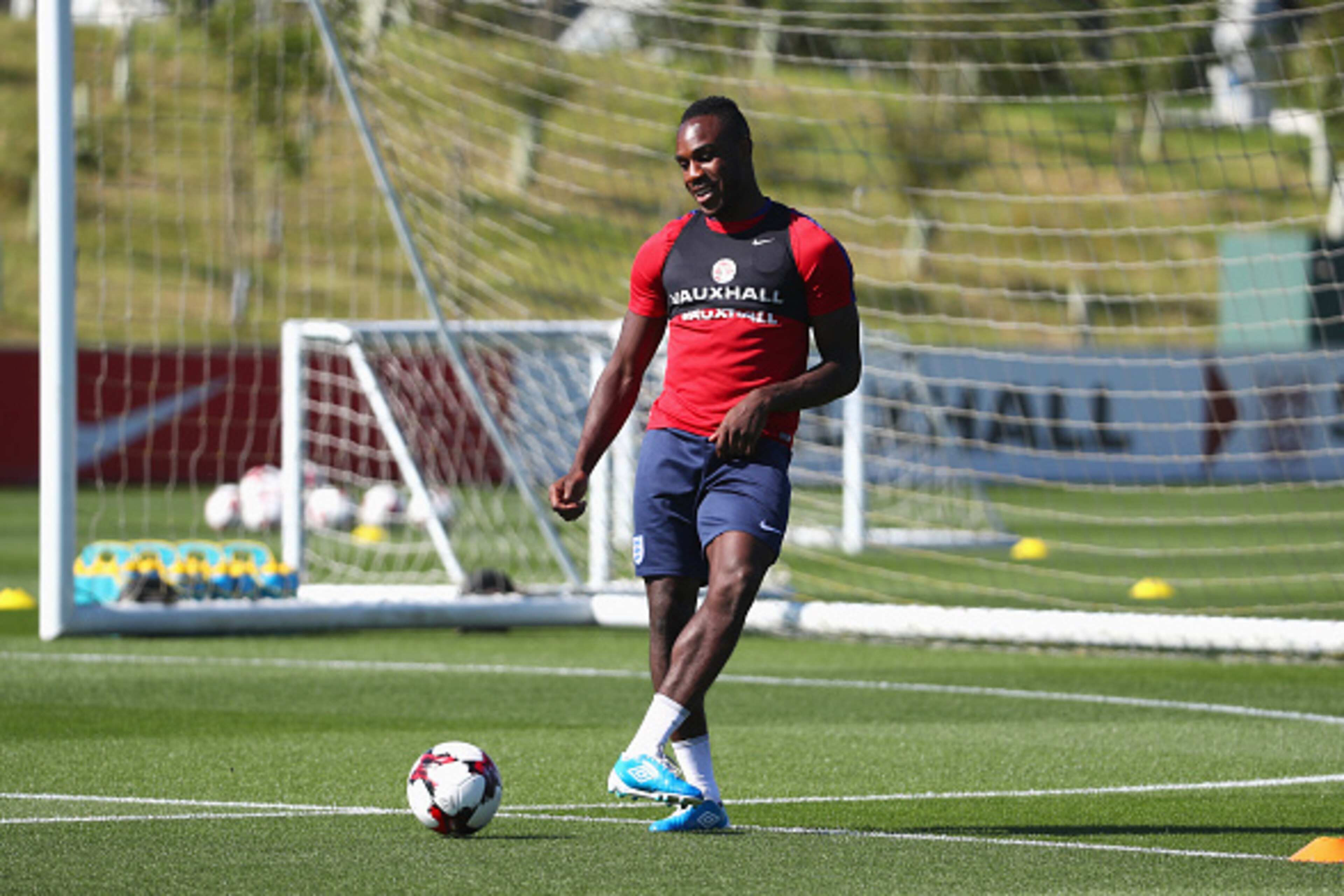 BURTON-UPON-TRENT, ENGLAND - AUGUST 30:  Michail Antonio of England passes during an England training session at St George's Park on August 30, 2016 in Burton-upon-Trent, England.  (Photo by Matthew Lewis/Getty Images)