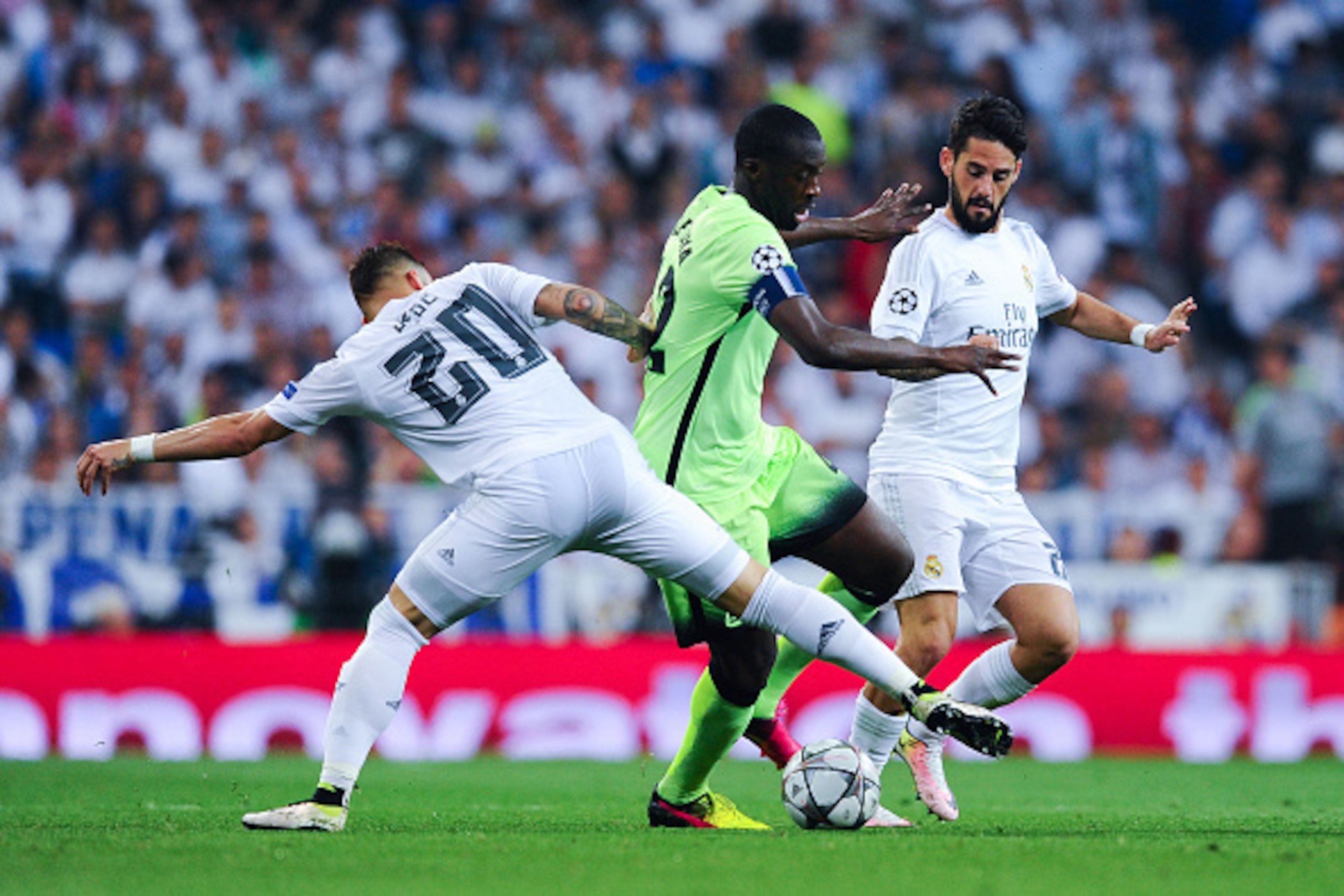 MADRID, SPAIN - MAY 04:  Yaya Toure of Manchester City FC competes for the ball with Jese Rodriguez and Isco Alarcon of Real Madrid CF during the UEFA Champions League Semi Final second leg match between Real Madrid and Manchester City FC at Estadio Santi