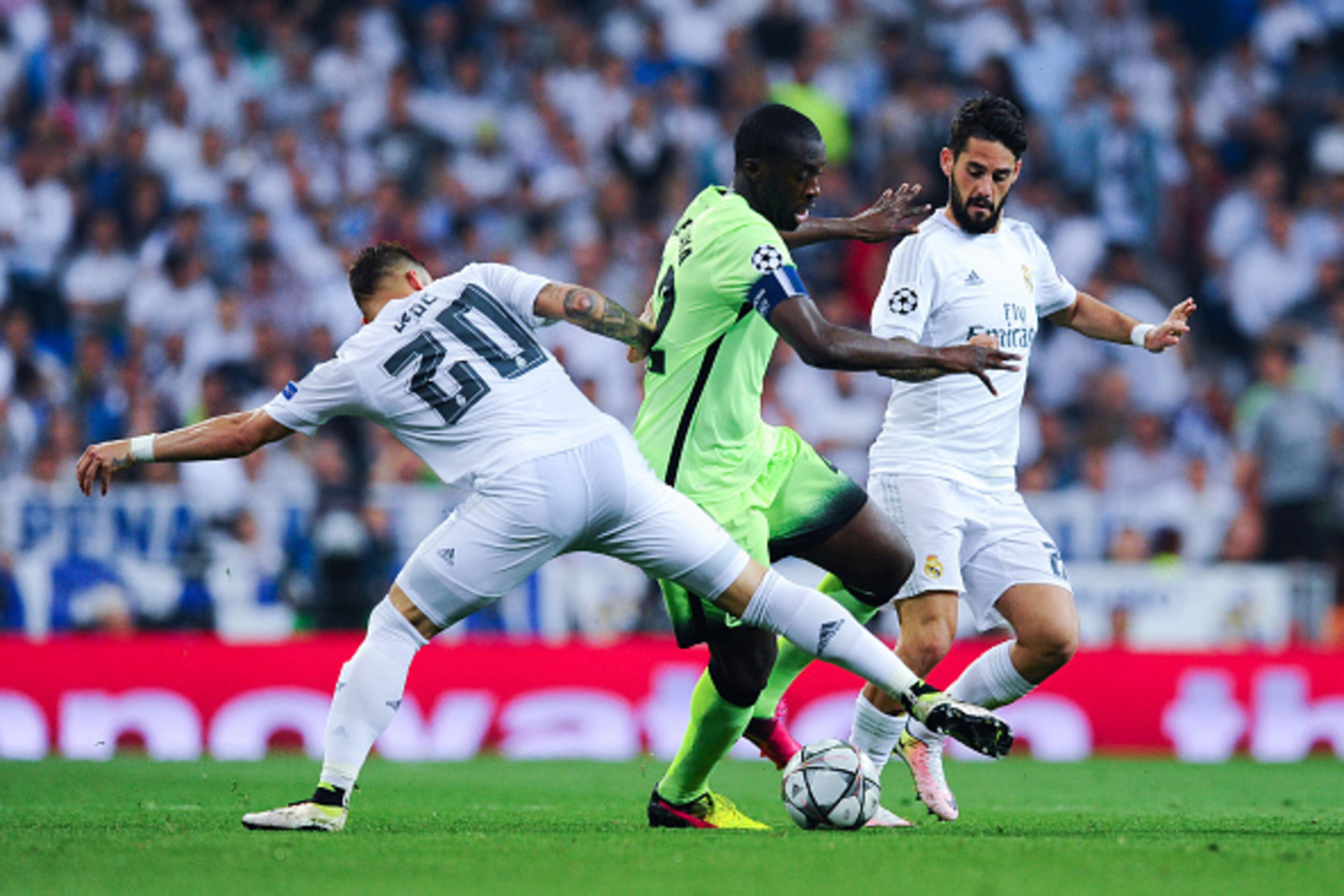 MADRID, SPAIN - MAY 04: Yaya Toure of Manchester City FC competes for the ball with Jese Rodriguez and Isco Alarcon of Real Madrid CF during the UEFA Champions League Semi Final second leg match between Real Madrid and Manchester City FC at Estadio Santi MADRID, SPAIN - MAY 04: Yaya Toure of Manchester City FC competes for the ball with Jese Rodriguez and Isco Alarcon of Real Madrid CF during the UEFA Champions League Semi Final second leg match between Real Madrid and Manchester City FC at Estadio Santi