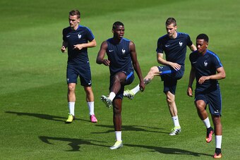 PARIS, FRANCE - JULY 09:  (L-R) Antoine Griezmann, Paul Pogba, Morgan Schneiderlin and Anthony Martial warm up during a France training session on the eve of the UEFA EURO 2016 Final against Portugal at Clairefontaine on July 9, 2016 in Paris, France.  (P