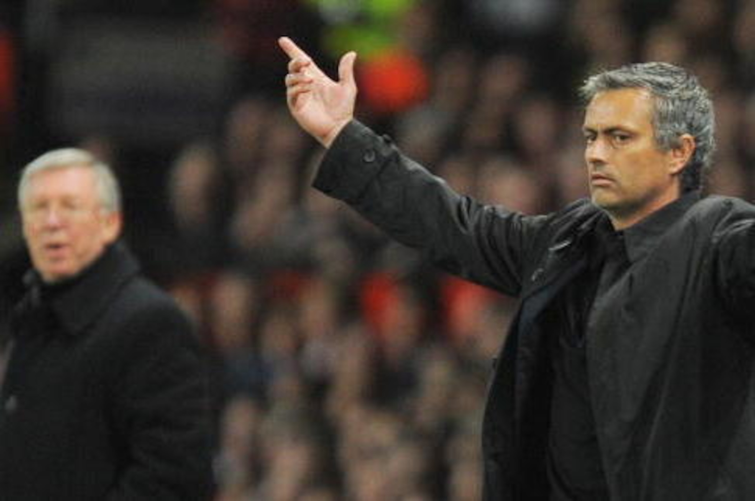 Inter Milan's Portuguese coach Jose Mourinho (R) gestures next to Manchester United manager Sir Alex Ferguson during their UEFA Champions League second round second leg football match at Old Trafford in Manchester, north west England on March 11, 2009.   