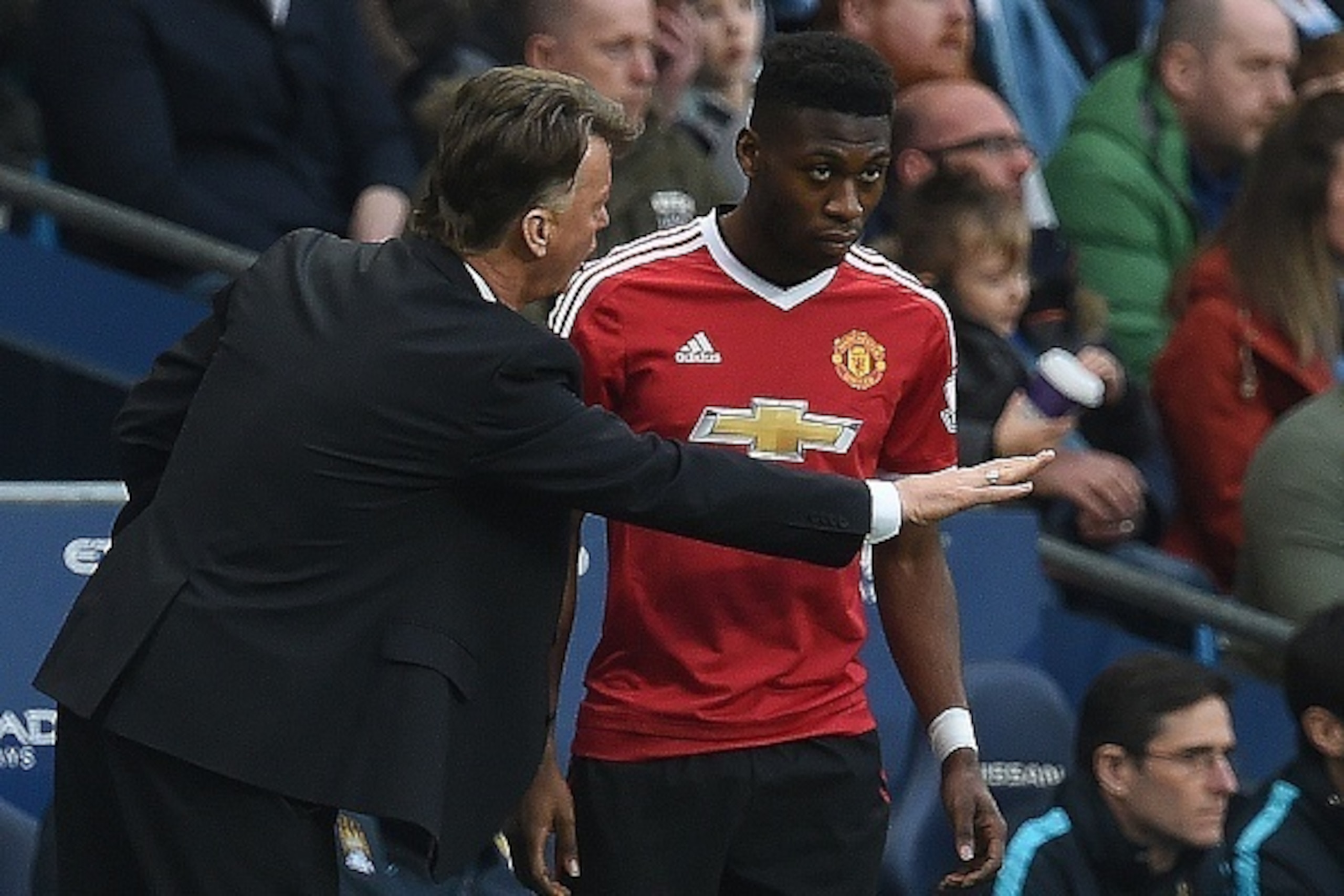 Manchester United's Dutch manager Louis van Gaal (L) gives instructions to Manchester United's Dutch defender Timothy Fosu-Mensah before being substitued on during the English Premier League football match between Manchester City and Manchester United at 