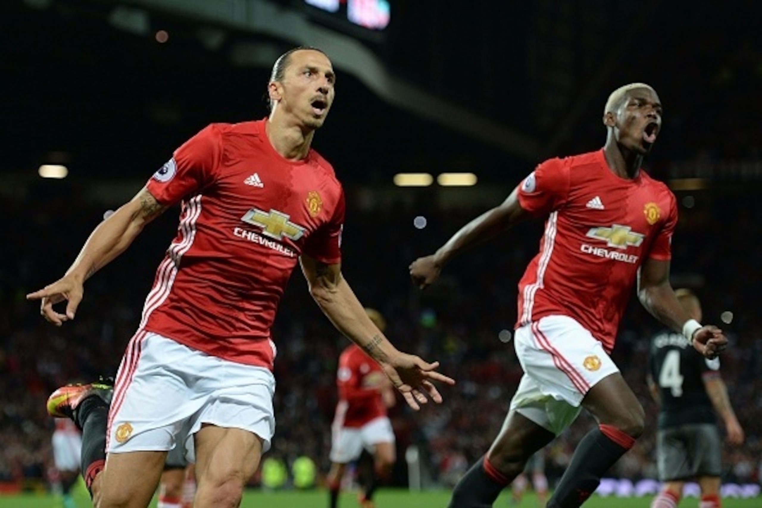 Manchester United's Swedish striker Zlatan Ibrahimovic (L) celebrates with Manchester United's French midfielder Paul Pogba after scoring their second goal from the penalty spot during the English Premier League football match between Manchester United an