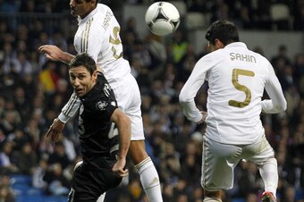 MADRID, SPAIN - DECEMBER 20: Nuri Sahin (R) of Real Madrid heads the ball to score Real's second goal during the round of last 16 Copa del Rey second leg match between Real Madrid and Ponferradina at Estadio Santiago Bernabeu on December 20, 2011 in Madri