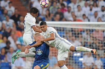 MADRID, SPAIN - AUGUST 27:  Henrique Casemiro and Rafael Varane of Real Madrid clash with John Guidetti of RC Celta de Vigo during the La Liga match between Real Madrid CF and RC Celta de Vigo at Estadio  Santiago Bernabeu on August 27, 2016 in Madrid, Sp
