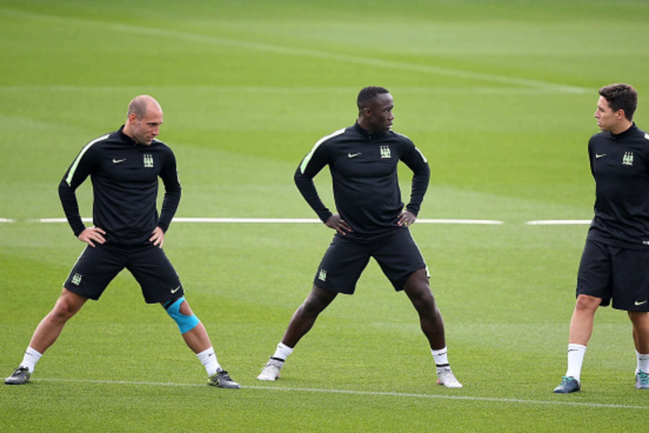 MANCHESTER, ENGLAND - SEPTEMBER 29:  (L-R) Pablo Zabaleta, Bacary Sagna and Samir Nasri chat during a Manchester City training session ahead of their Champions League fixture against Borussia Moenchengladbach at City Football Academy on September 29, 2015