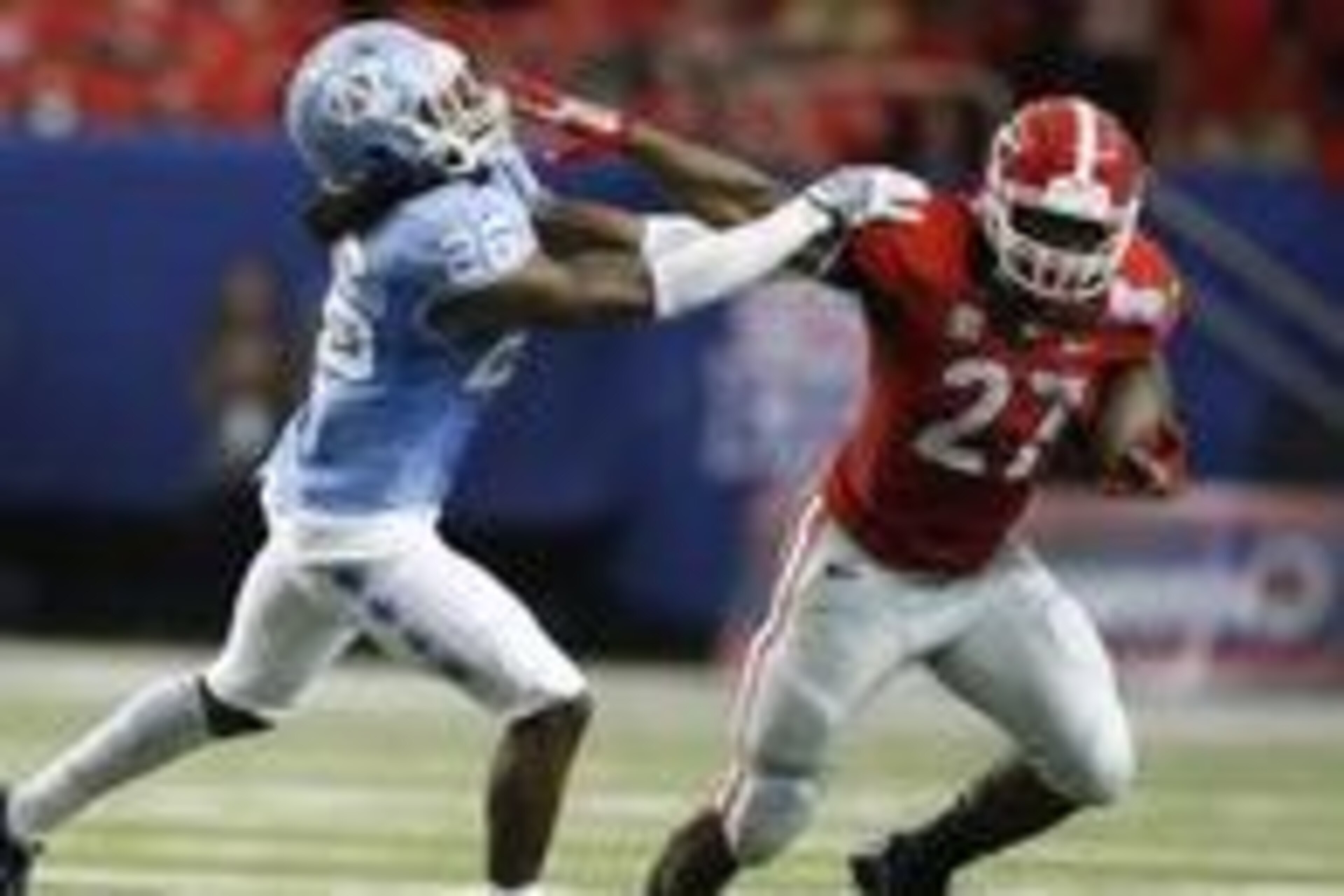 Sep 3, 2016; Atlanta, GA, USA;  Georgia Bulldogs running back Nick Chubb (27) runs the ball against North Carolina Tar Heels safety Dominquie Green (26) during the second quarter of the 2016 Chick-Fil-A Kickoff game at Georgia Dome. Mandatory Credit: Bret