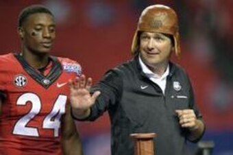 Sep 3, 2016; Atlanta, GA, USA;  Georgia Bulldogs head coach Kirby Smart puts on the Old Leather Helmet after the 2016 Chick-Fil-A Kickoff game against the North Carolina Tar Heels at Georgia Dome. Georgia won 33-24. Mandatory Credit: Dale Zanine-USA TODAY