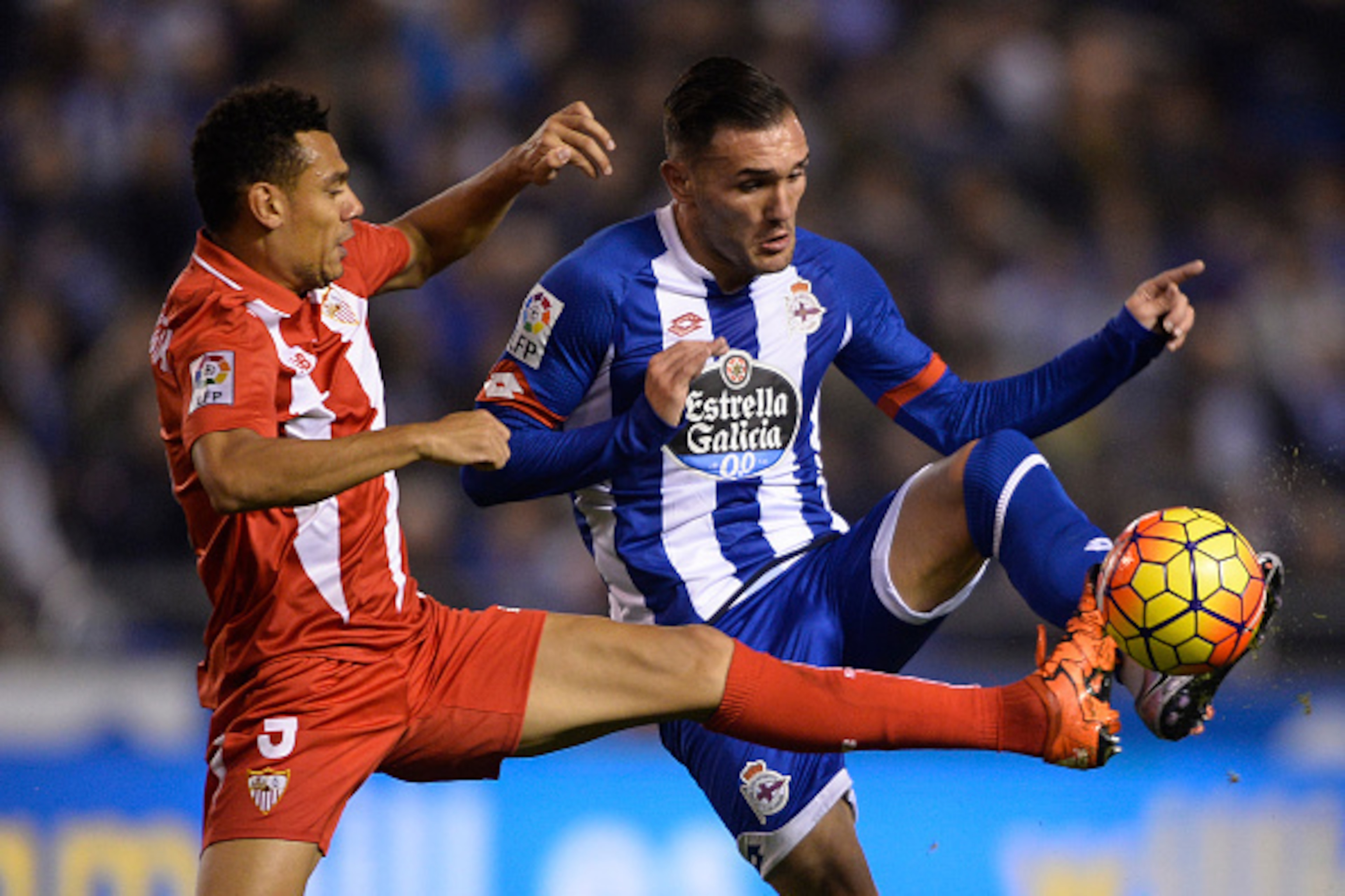 Sevilla's French defender Thimothee Kolodziejczak (L) vies with Deportivo La Coruna's midfielder Lucas Perez during the Spanish league football match RC Deportivo de la Coruna vs Sevilla FC at the Municipal de Riazor stadium in La Coruna on December 5, 20