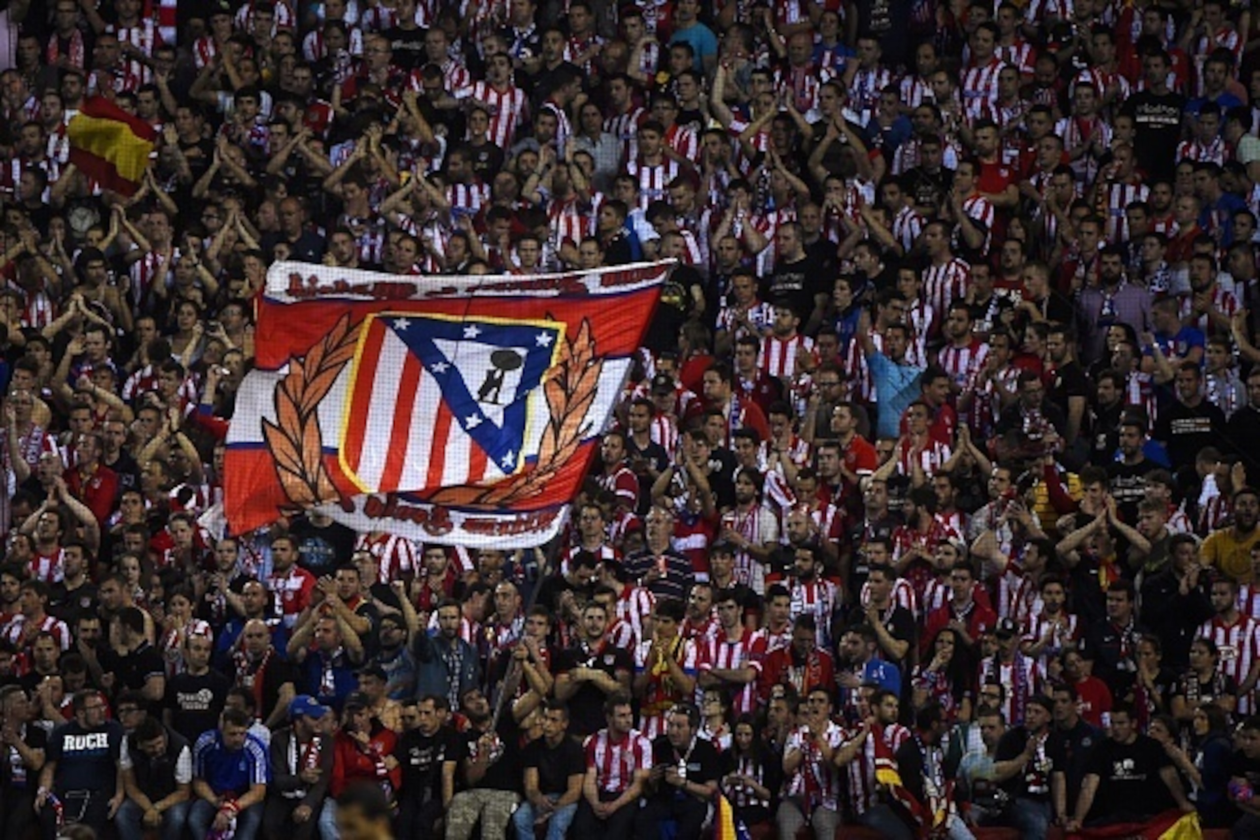 Atletico Madrid's supporters attend the UEFA Champions League quarter final football match Club Atletico de Madrid vs Barcelona at the Vicente Calderon stadium in Madrid on April 9, 2014.  AFP PHOTO / PIERRE-PHILIPPE MARCOU        (Photo credit should rea