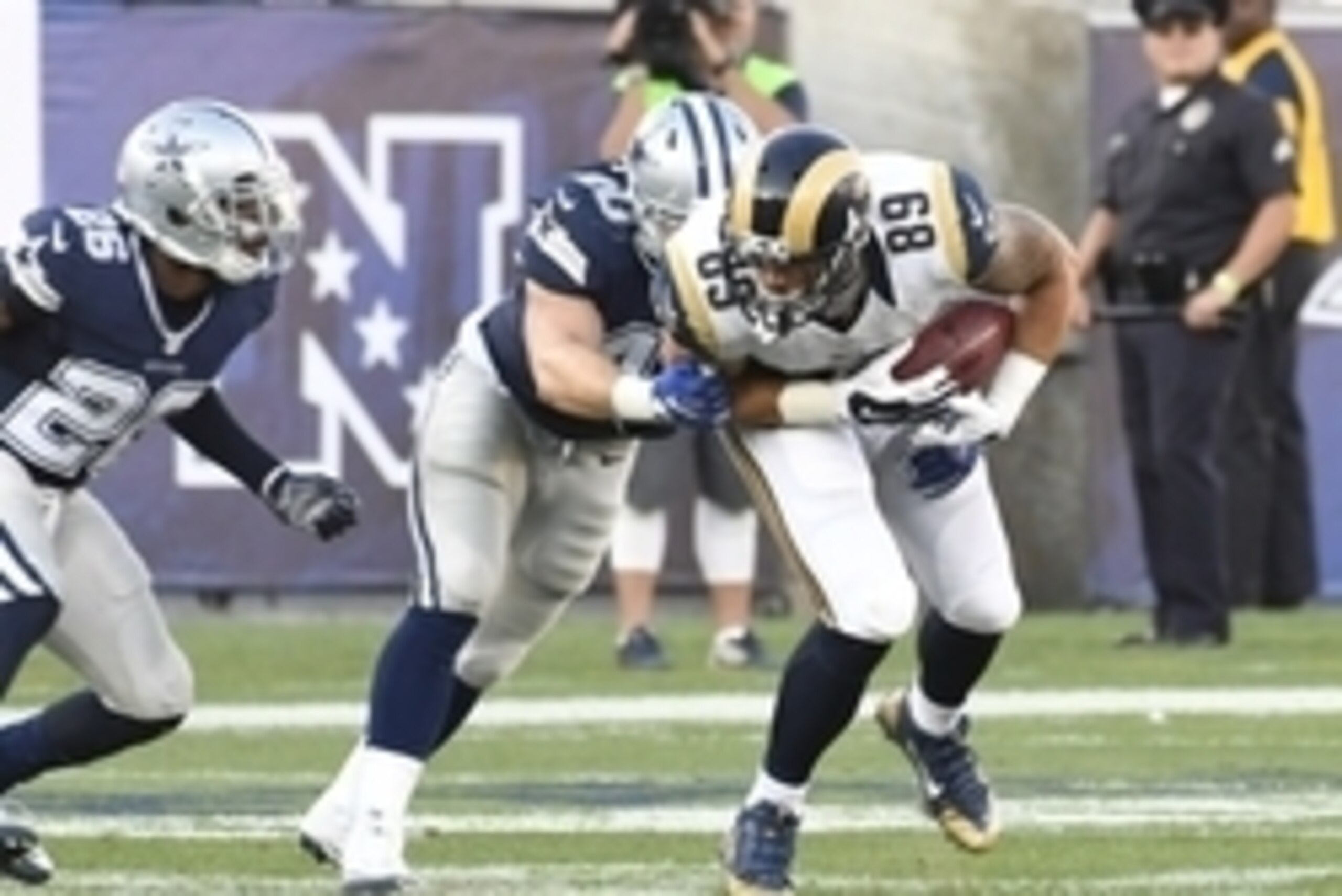 Aug 13, 2016; Los Angeles, CA, USA; Dallas Cowboys linebacker James Morris (40) tackles Los Angeles Rams tight end Tyler Higbee (89) during the third quarter at Los Angeles Memorial Coliseum. Mandatory Credit: Richard Mackson-USA TODAY Sports