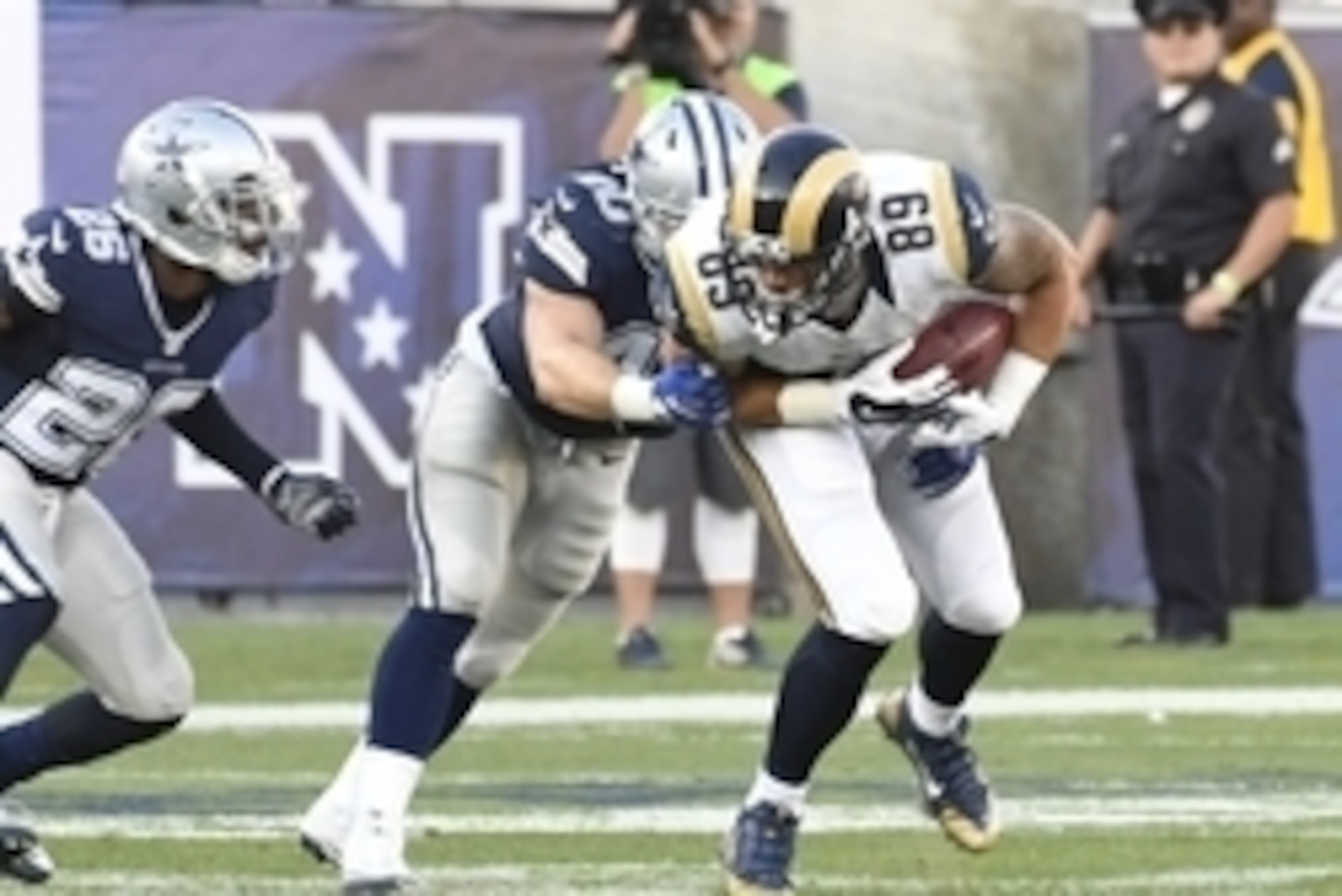 Aug 13, 2016; Los Angeles, CA, USA; Dallas Cowboys linebacker James Morris (40) tackles Los Angeles Rams tight end Tyler Higbee (89) during the third quarter at Los Angeles Memorial Coliseum. Mandatory Credit: Richard Mackson-USA TODAY Sports