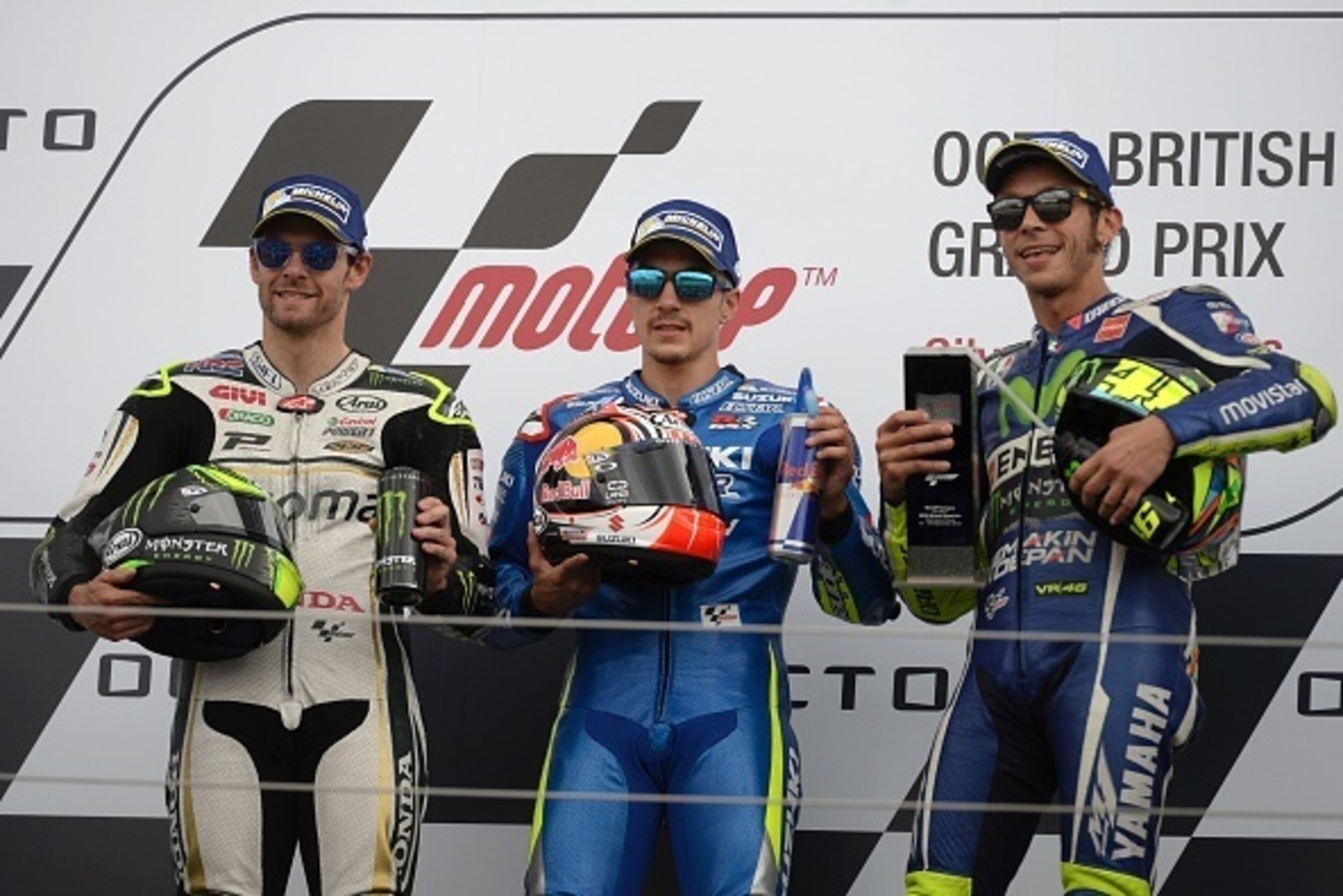 Winner Team Suzuki ECSTAR Maverick Vinales (C), second-placed LCR Honda's British rider Cal Crutchlow (L) and third-placed Movistar Yamaha MotoGP's Italian rider Valentino Rossi (R) pose on the podium after the MotoGP race at the motorcycling British Gran