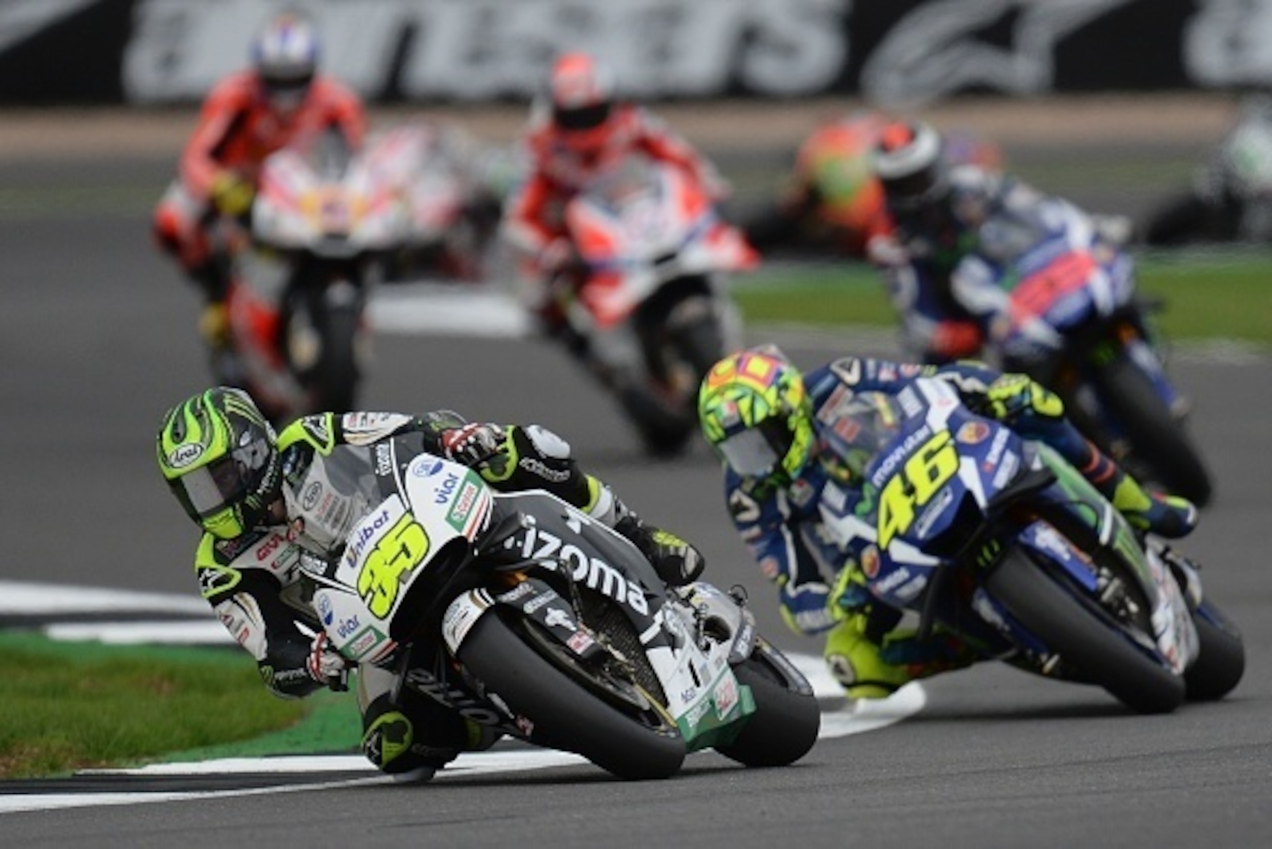 LCR Honda's British rider Cal Crutchlow (L) leads Movistar Yamaha MotoGP's Italian rider  Valentino Rossi (R) through Luffield Corner during the MotoGP race at the motorcycling British Grand Prix at Silverstone circuit in Northamptonshire, southern Englan